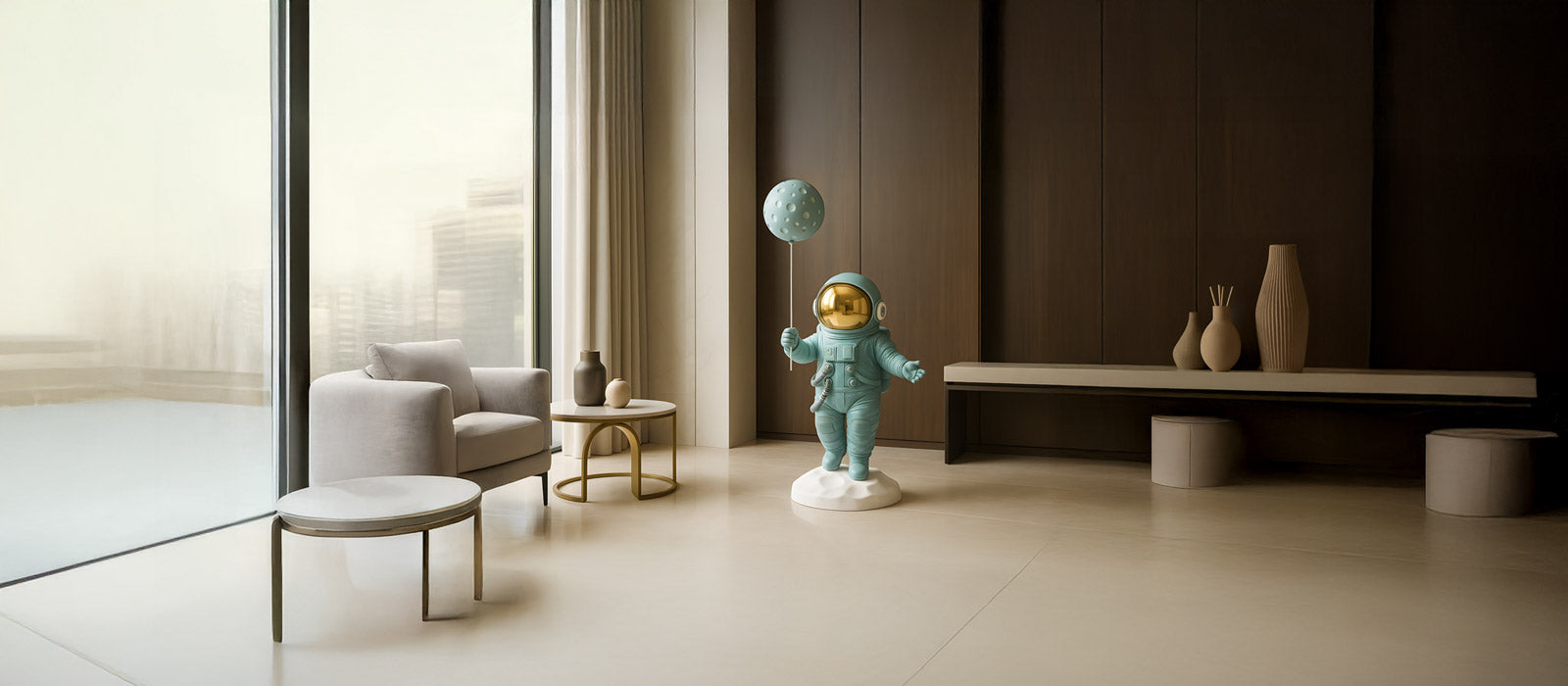 A modern room features a metallic astronaut sculpture with a balloon, standing on a cloud base. The space includes a sofa, geometric art on the wall, and a pouf on a wooden floor.