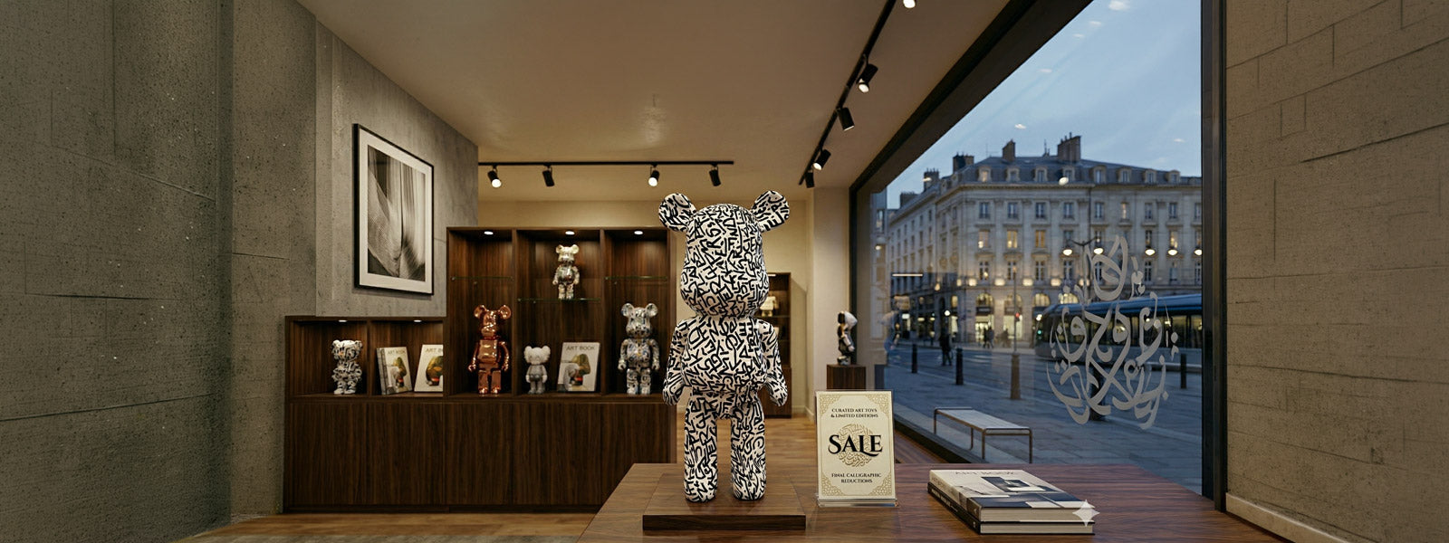 Showroom with a large black-and-white calligraphy-patterned bear sculpture on a wooden platform, smaller figures on walnut shelves, art books, and a Sale sign.