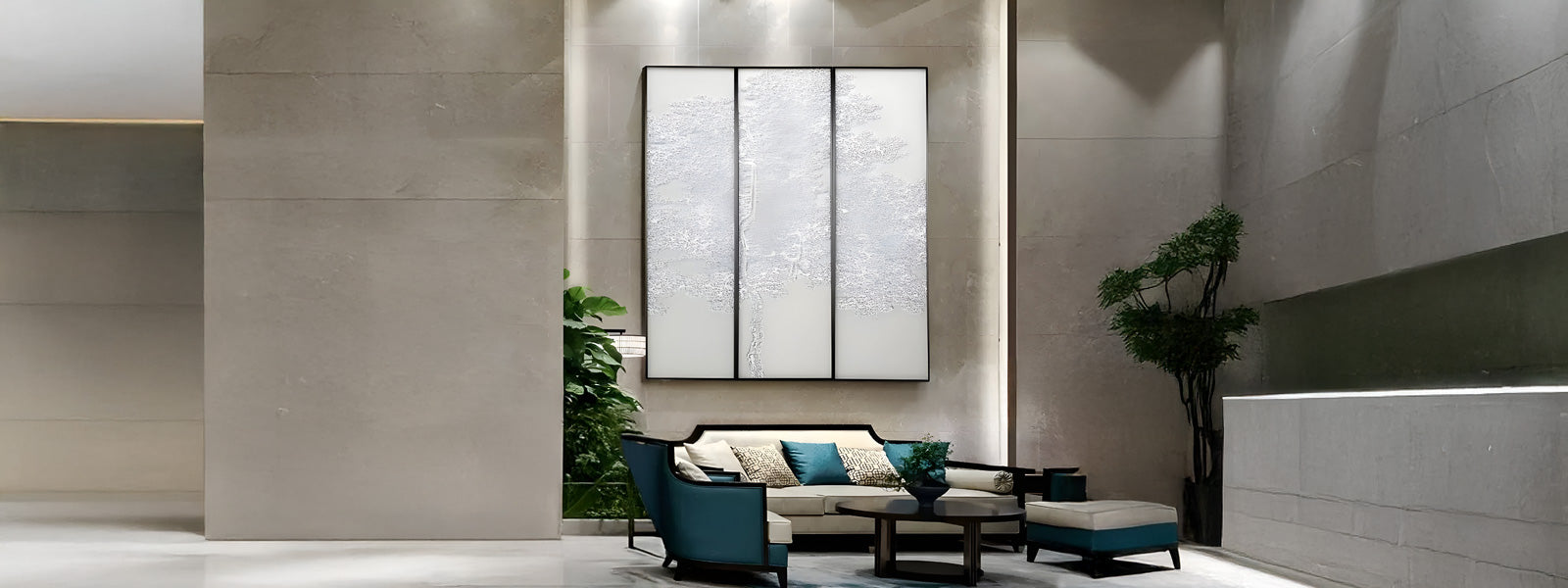 Three-panel white textured silk art piece on a tall beige stone wall above a modern seating area with cream sofa, teal armchairs, coffee table, and greenery.