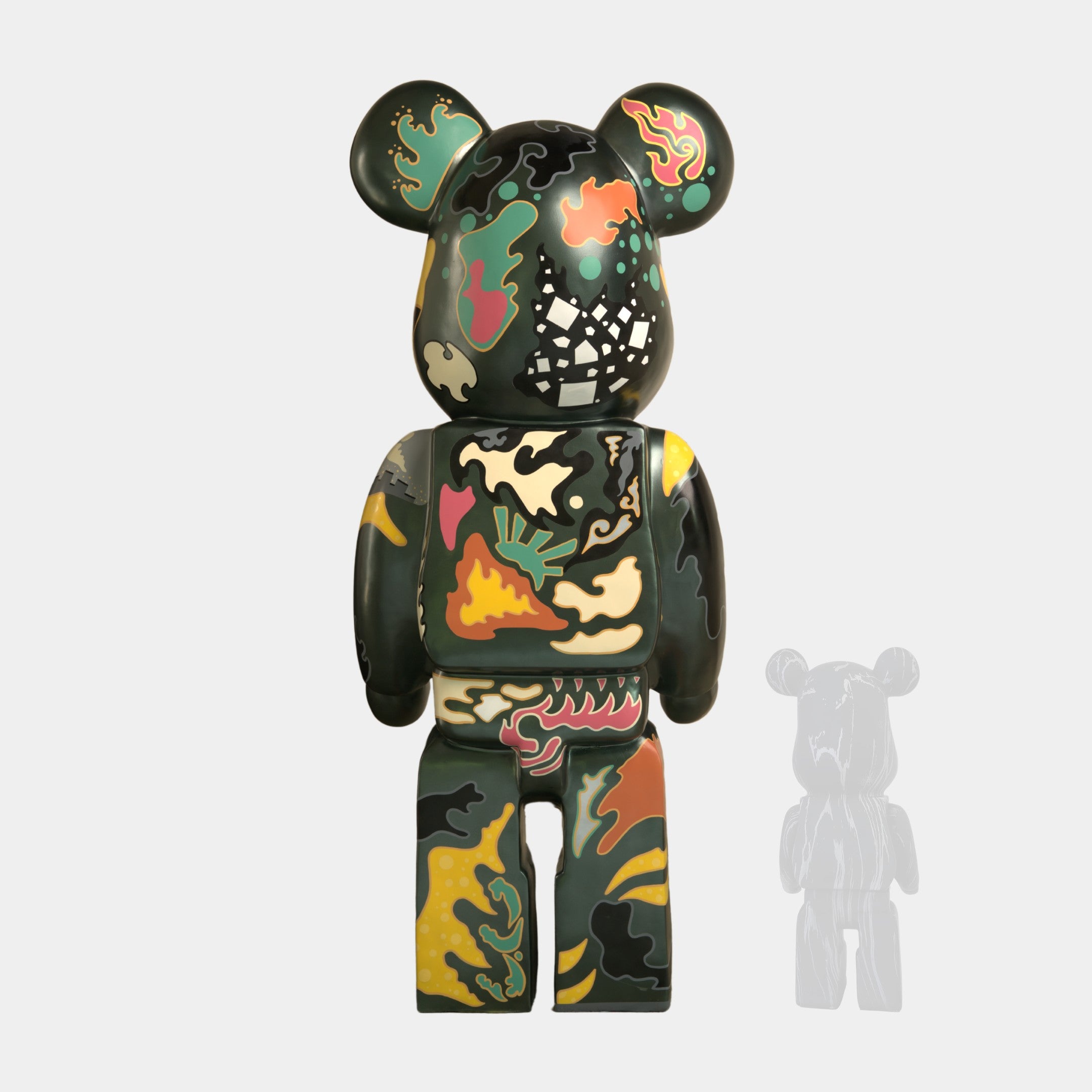 The Inside Appears Outside Bear Sculpture - 50cm by Giant Sculptures is a limited edition figurine inspired by Jirayu Tantrakul, featuring a patchwork of abstract shapes in green, yellow, orange, black, and white.