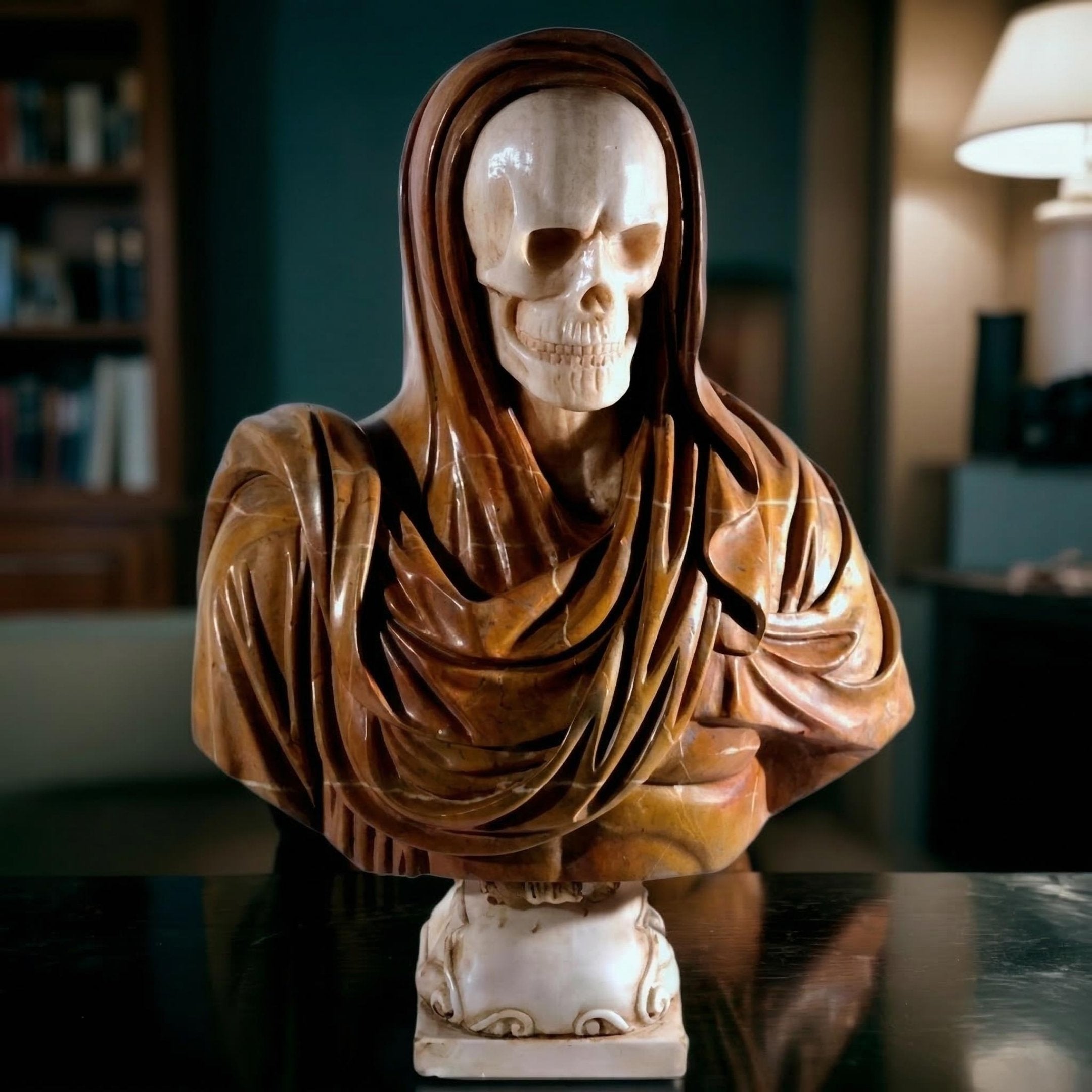 The Giant Sculptures Memento Mori Skull Marble Bust Sculpture (90cm) sits on a table, making a striking art piece against shelves of books and the soft glow of a lamp.
