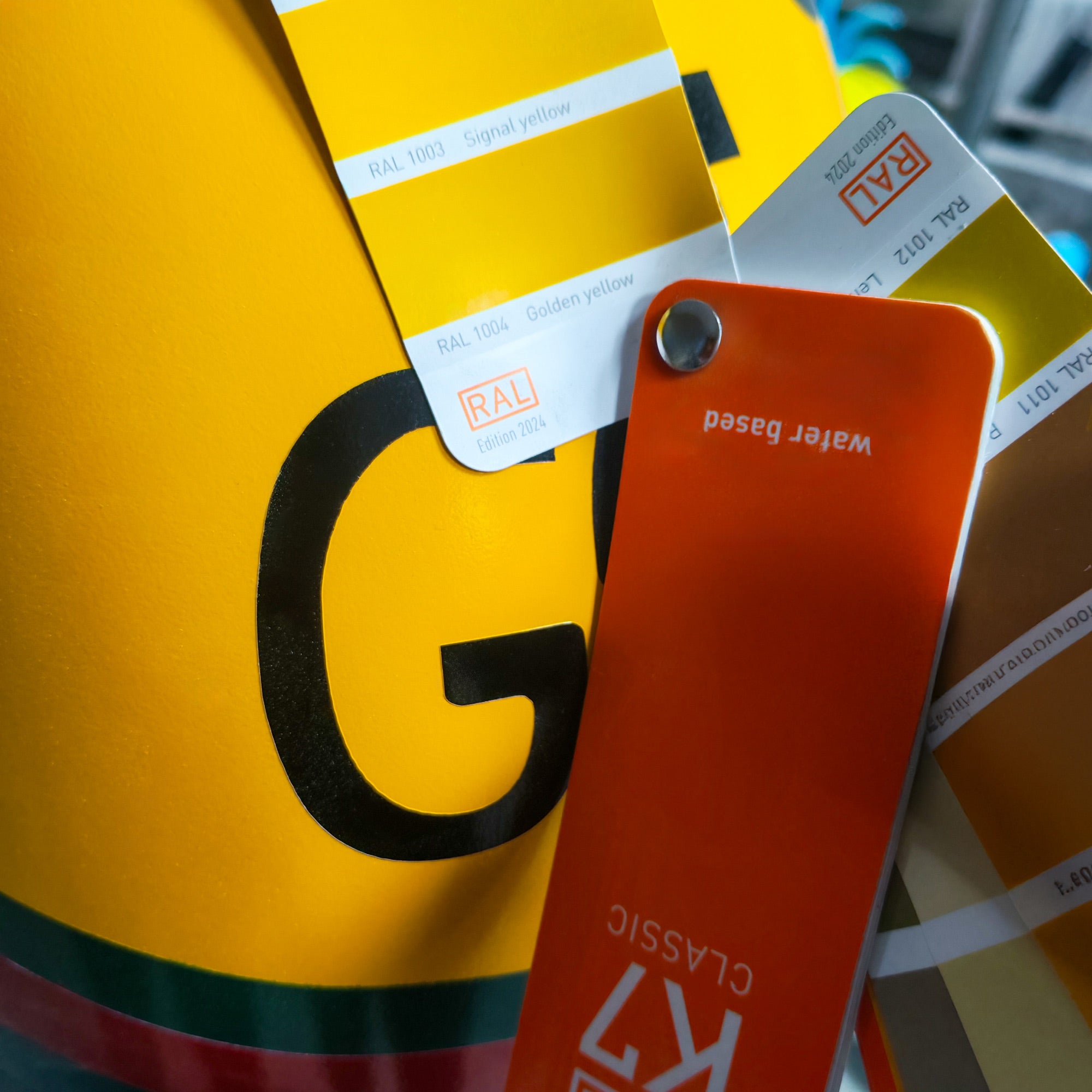 Colour swatches including a yellow swatch with a large 'G' and red swatch labeled 'Water Base'.