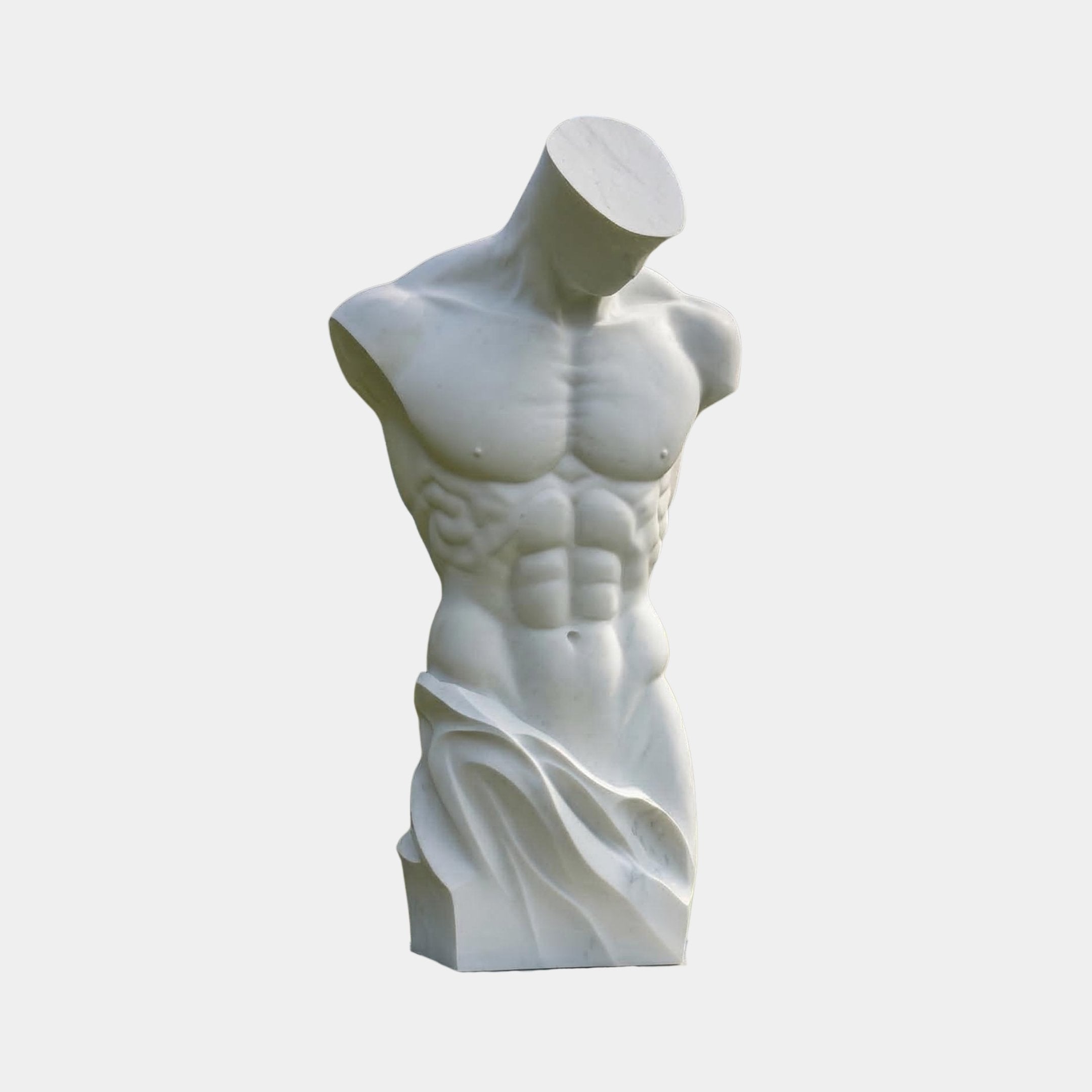 The Male Marble Torso Sculpture - 100cm by Giant Sculptures features a headless and limbless male figure in natural white marble, with defined musculature and draped details against a plain, light background.