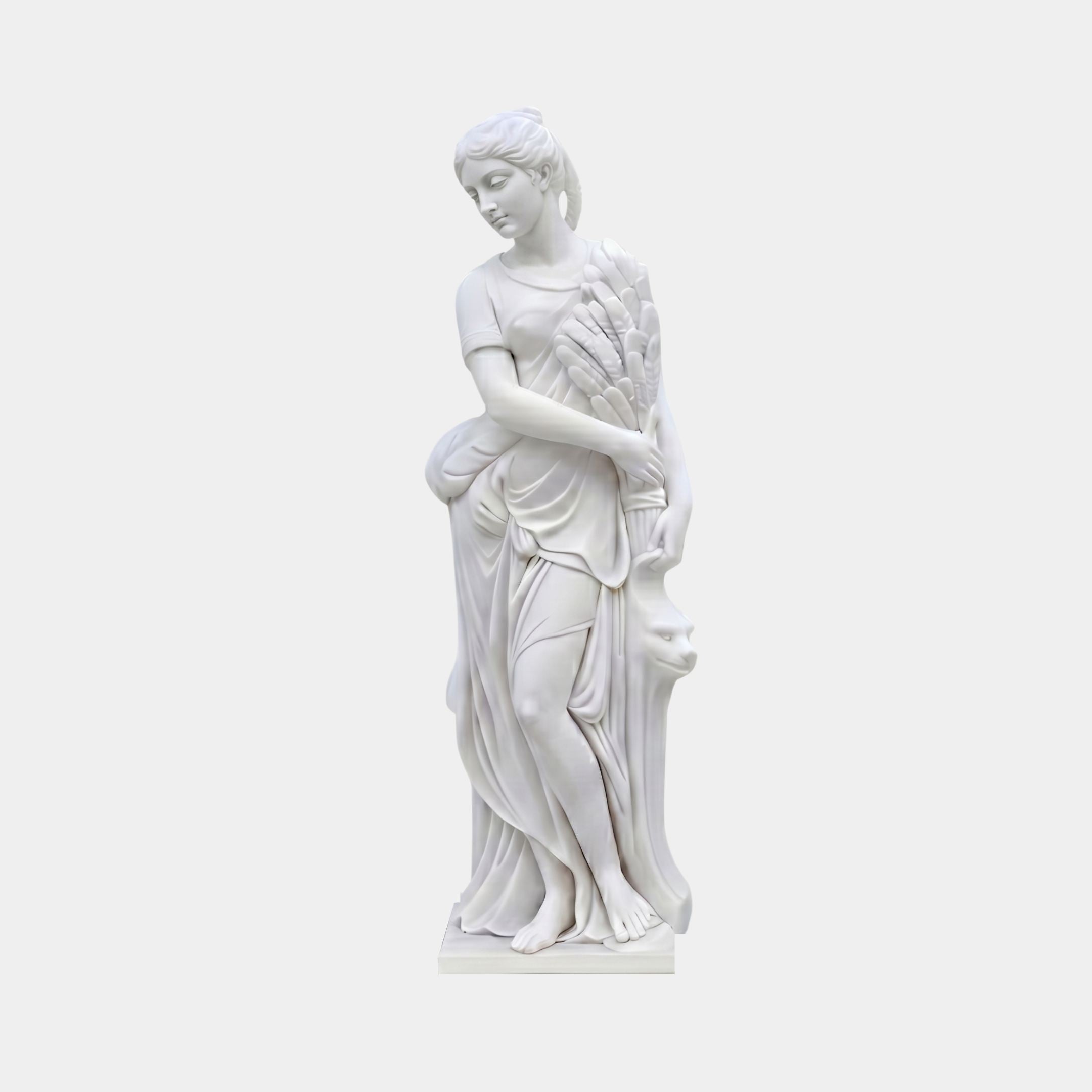 Goddess of the Harvest 180cm marble sculpture by Giant Sculptures, depicting a robed female figure cradling a sheaf of wheat beside a carved lion head support.
