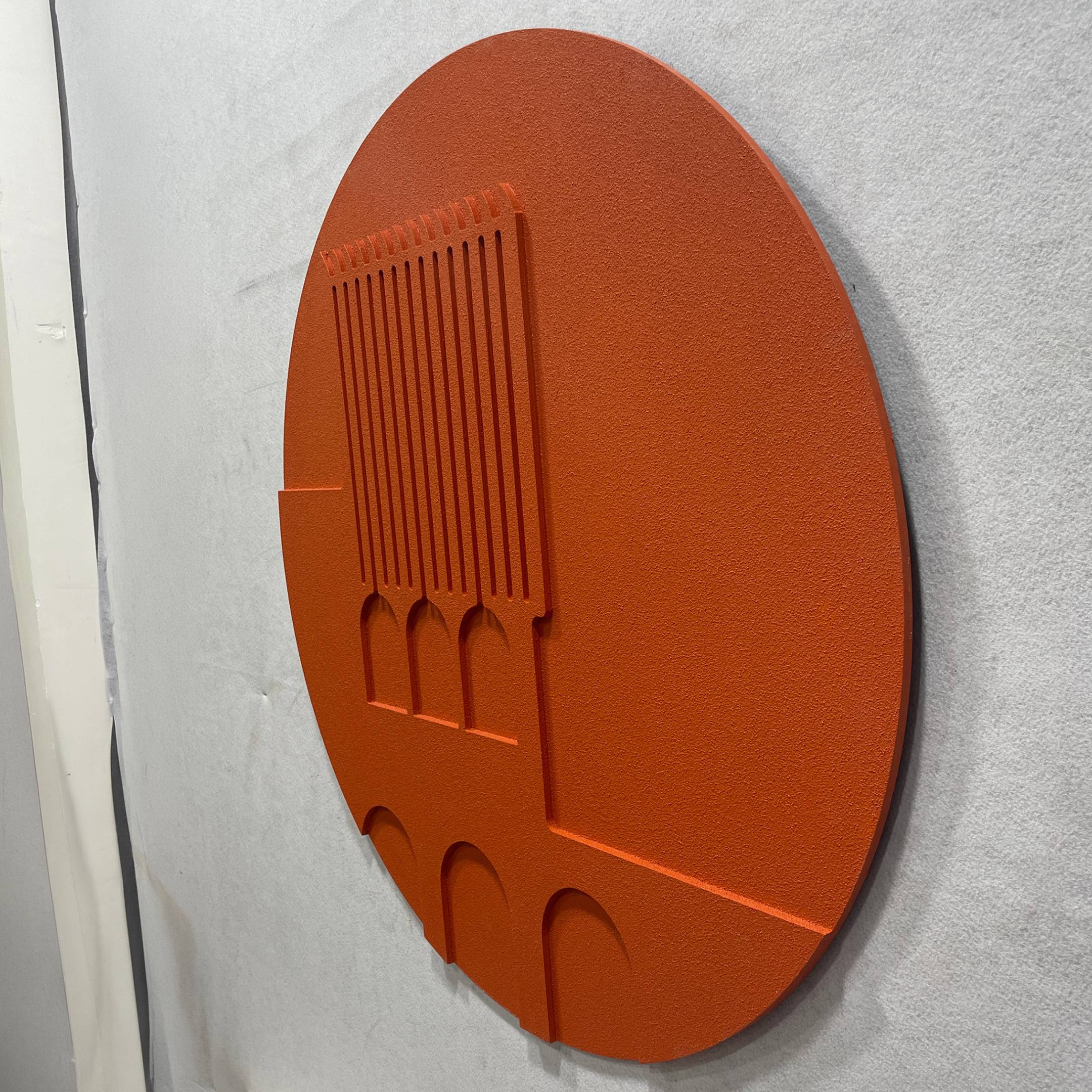 Angled side view of the Arcuza Terracotta I Wood Carving Sandstone 3D Wall Art by Giant Sculptures, showing carved vertical slats and arched recesses on a matte terracotta disc.