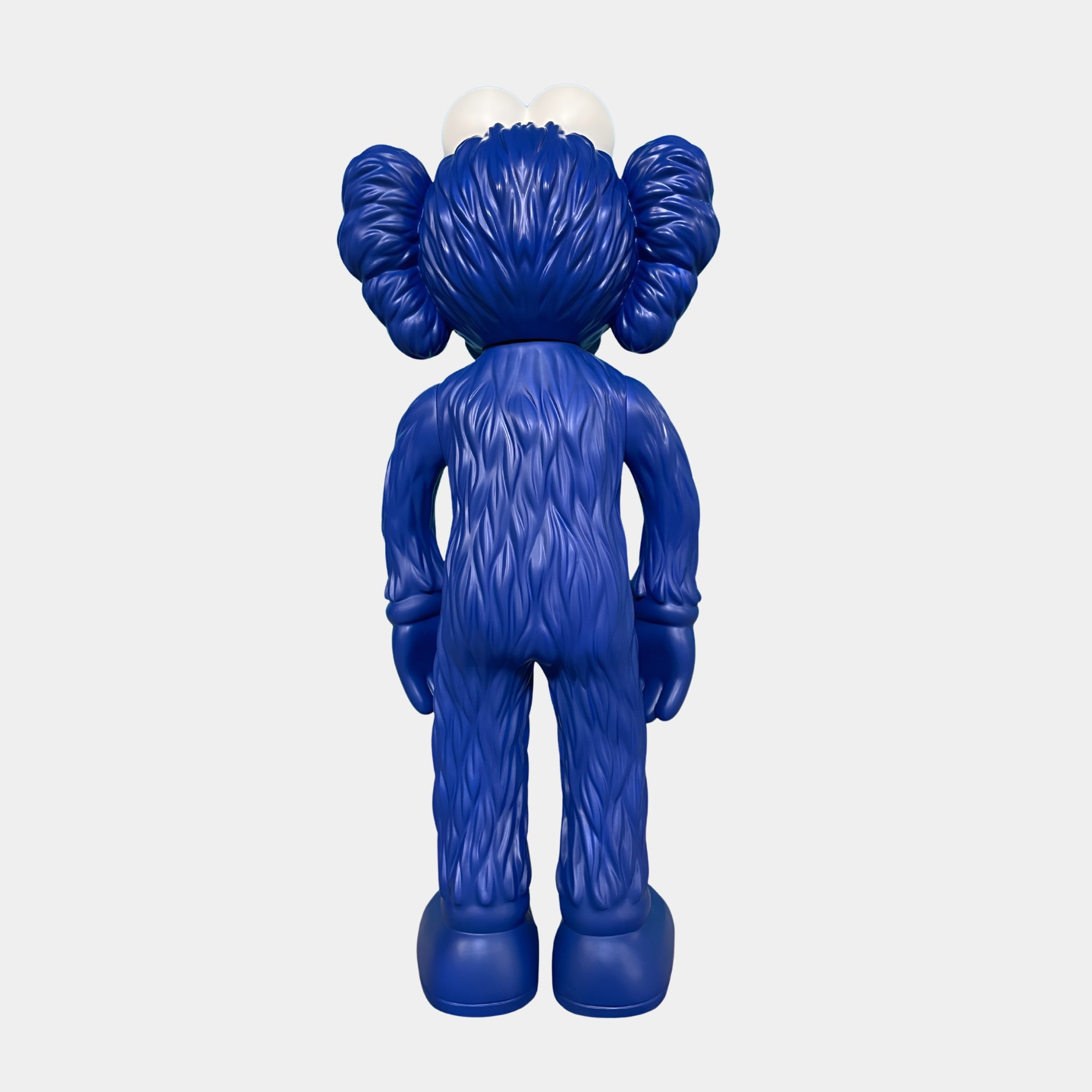 The Deep Blue Iconify Furry Figure by Giant Sculptures stands upright at 30cm, featuring large hands, feet, round ears, and two white shapes on its head resembling cartoon eyes—showcasing impressive sculptural craftsmanship.