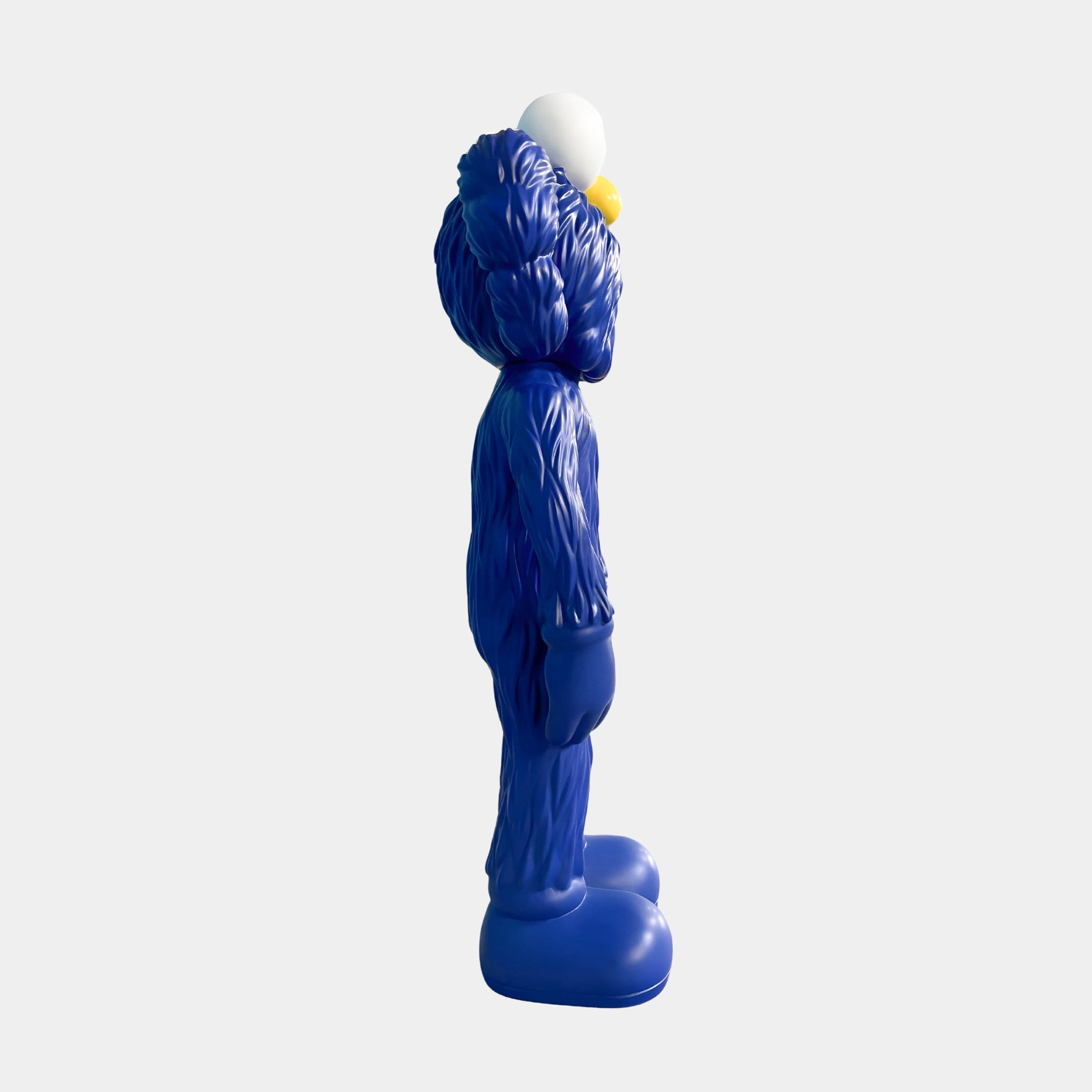 The Deep Blue Iconify Furry Figure - 30cm by Giant Sculptures is a blue, furry cartoon-style figure with large feet, rounded hands, and a white ball on its head, shown from the side against a plain light gray background.