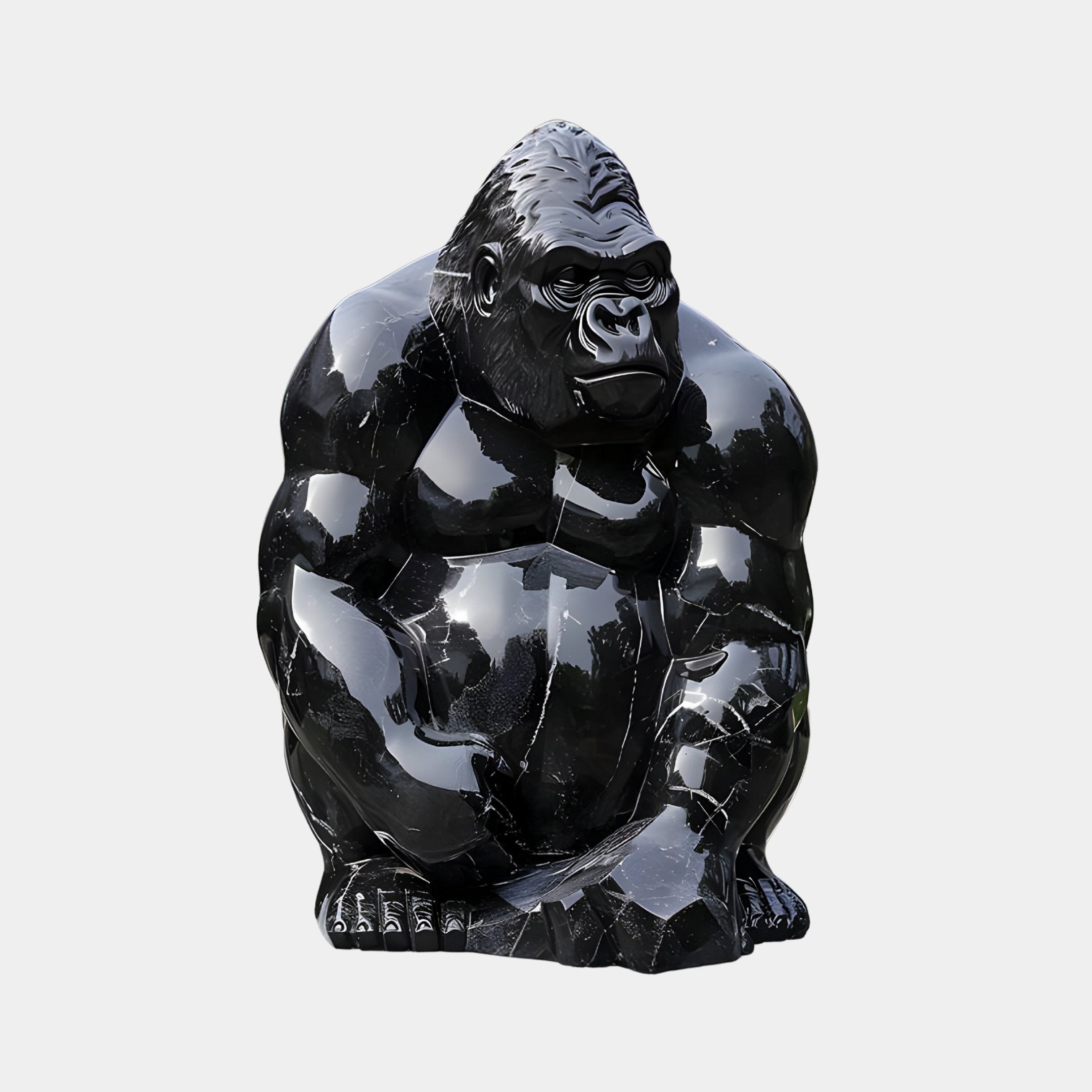 The Onyx Seated Gorilla Marble Outdoor Sculpture - 80cm by Giant Sculptures features a glossy gorilla sitting with arms on its knees and a focused expression, crafted from Black Dali Marble and standing out against any simple background.