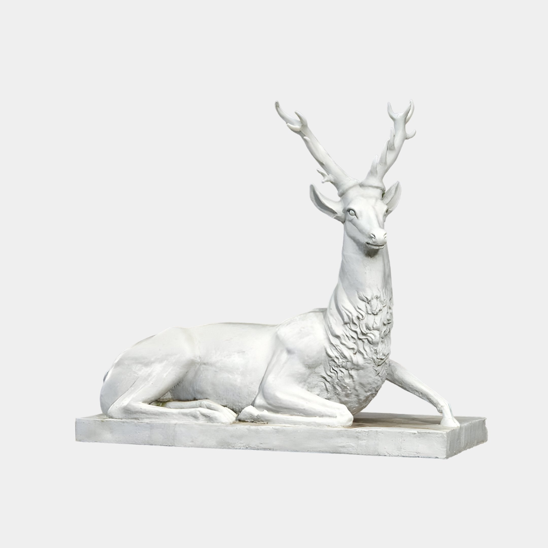 This Regal Lying Stag Marble Outdoor Sculpture by Giant Sculptures showcases a handcrafted white stag with detailed antlers and fur, set on a rectangular base. It epitomizes elegant outdoor artistry, measuring 150cm.