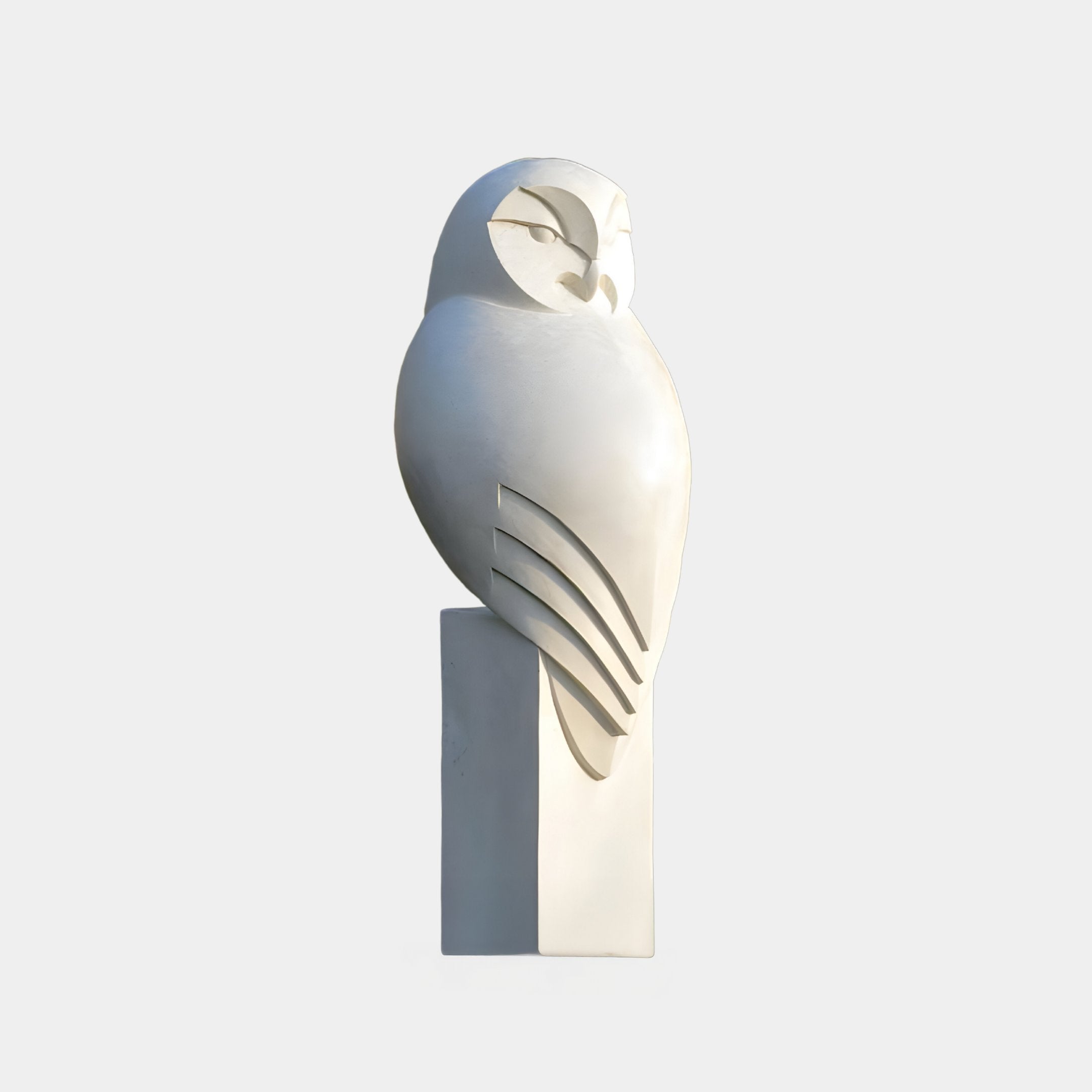 The Minimalist Perched Owl Marble Outdoor Sculpture by Giant Sculptures features a smooth, stylized owl with engraved eyes and wing lines on a rectangular pedestal, enhancing contemporary outdoor decor with its elegant simplicity.