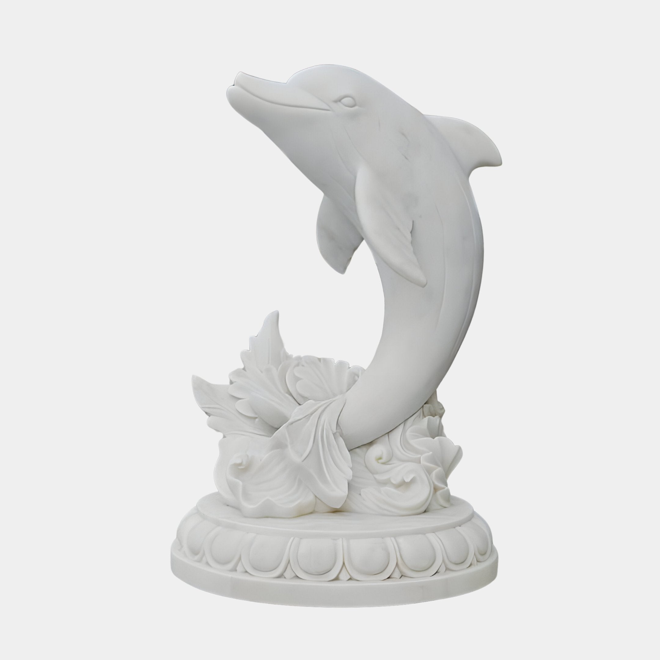The Leaping Dolphin Marble Outdoor Sculpture by Giant Sculptures, standing at 150cm, embodies marine life with a white dolphin ascending through stylized waves and foliage. Ideal for outdoor use, it brings oceanic charm to any space against its plain background.