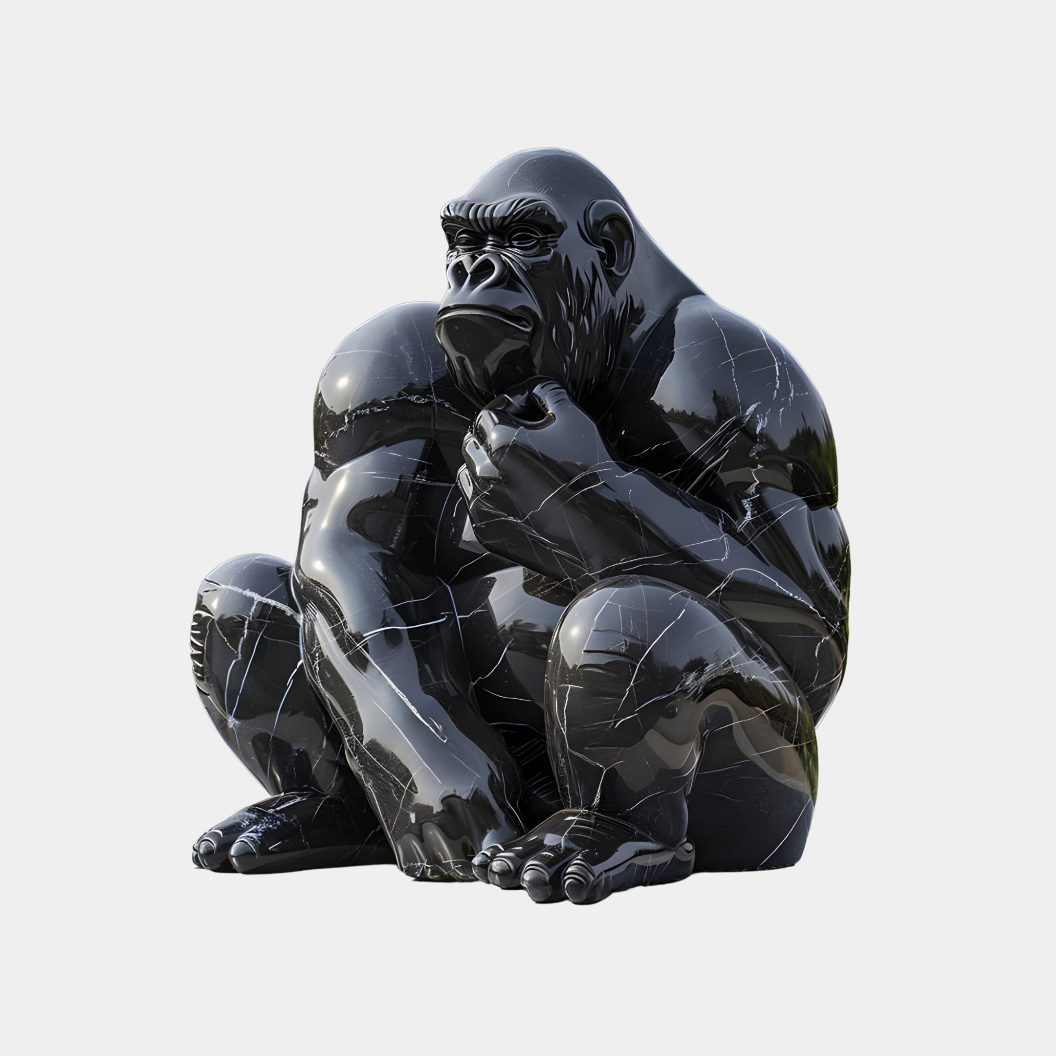 The Ebony Watchful Gorilla Marble Outdoor Sculpture - 80cm by Giant Sculptures is a shiny, black statue in a seated pose on a gray background. This polished marvel boasts smooth surfaces and reflective highlights that accentuate its muscular structure.