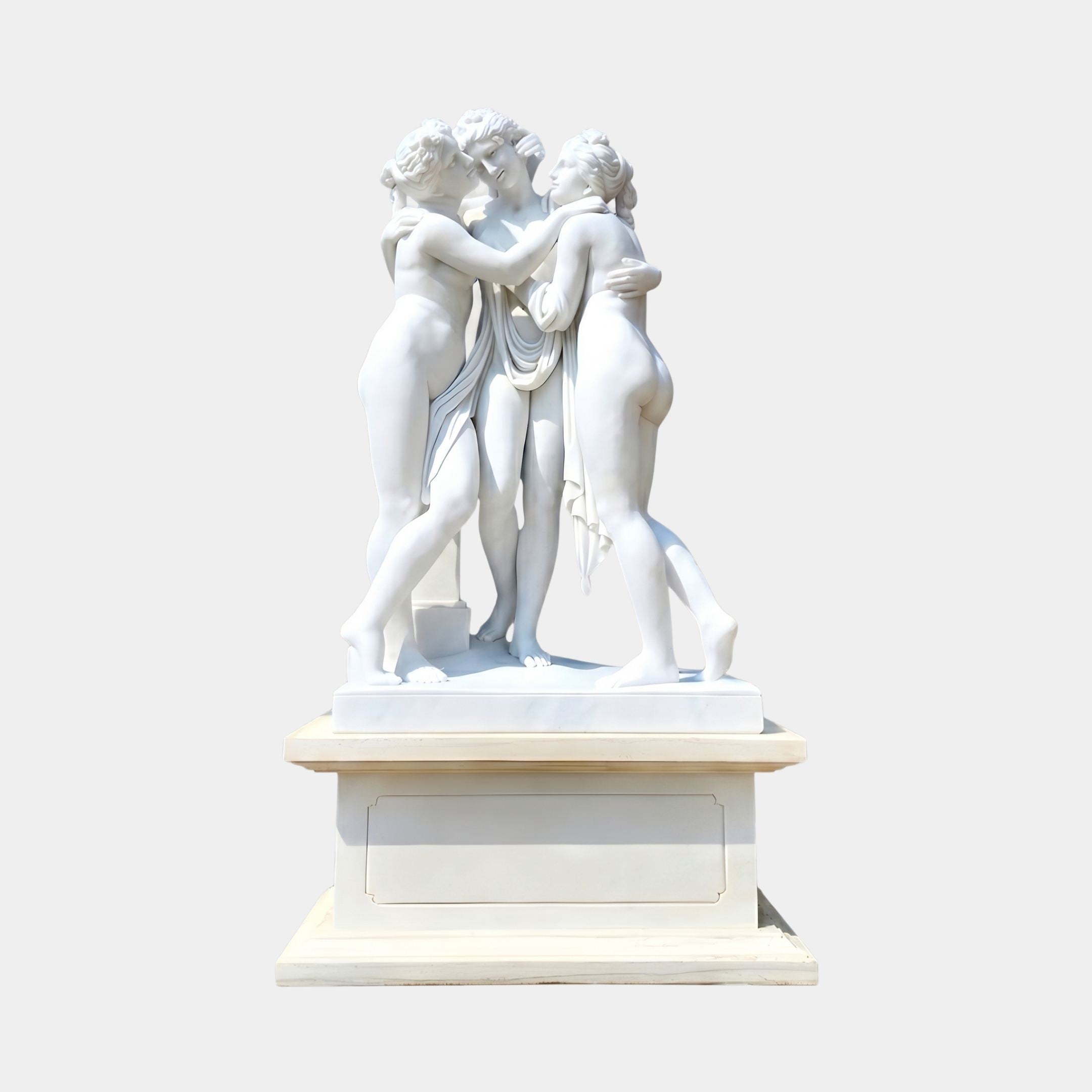 The Three Graces Marble Sculpture by Giant Sculptures, depicting three intertwined nude female figures in white marble on a matching pedestal against a plain grey background.