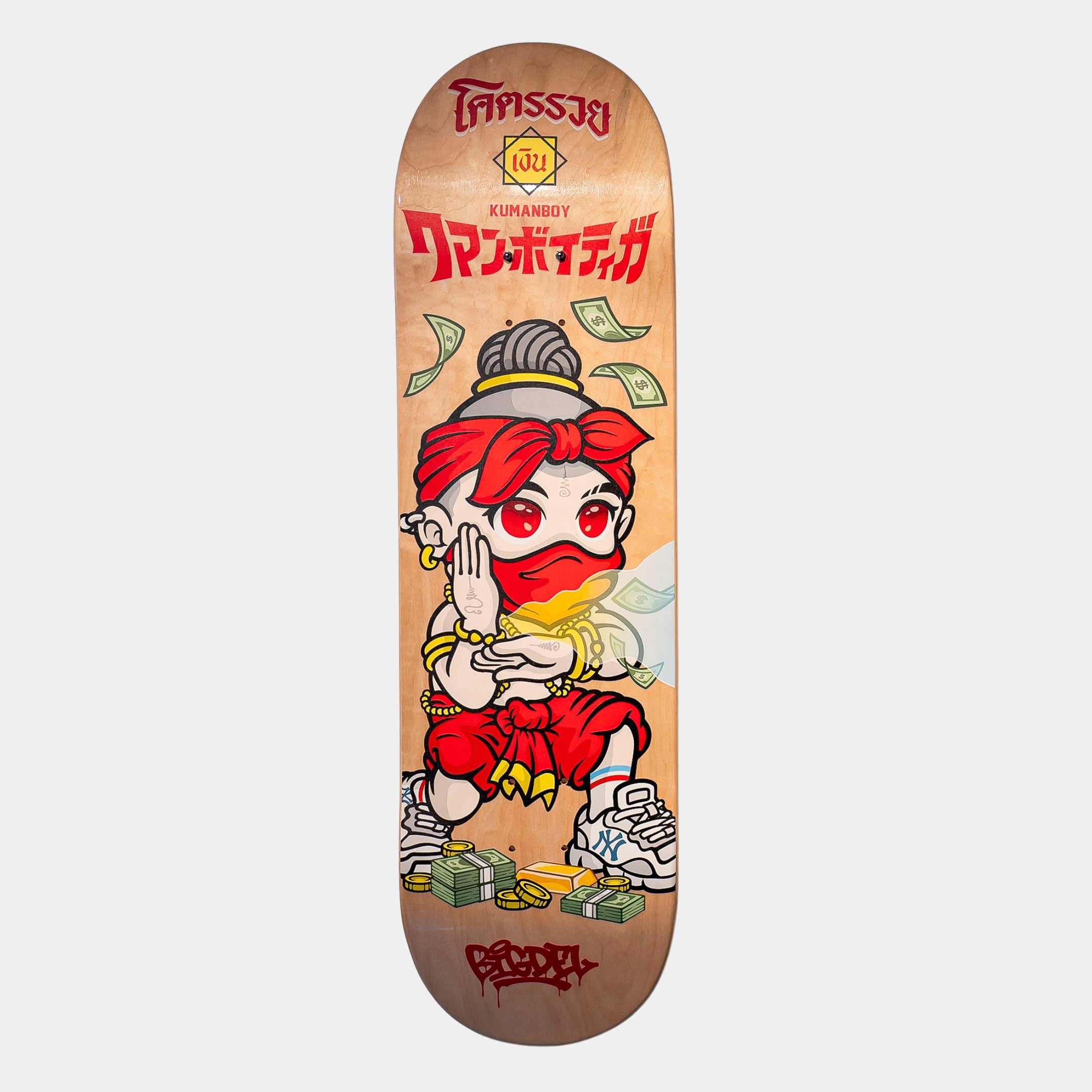 The Kuman Boy Deck Vol.1 by Giant Sculptures is a retro-pop skateboard wall art featuring a cartoon in a red headband, gold jewelry, sneakers, cash, coins, and Thai and Japanese text—a unique décor piece.