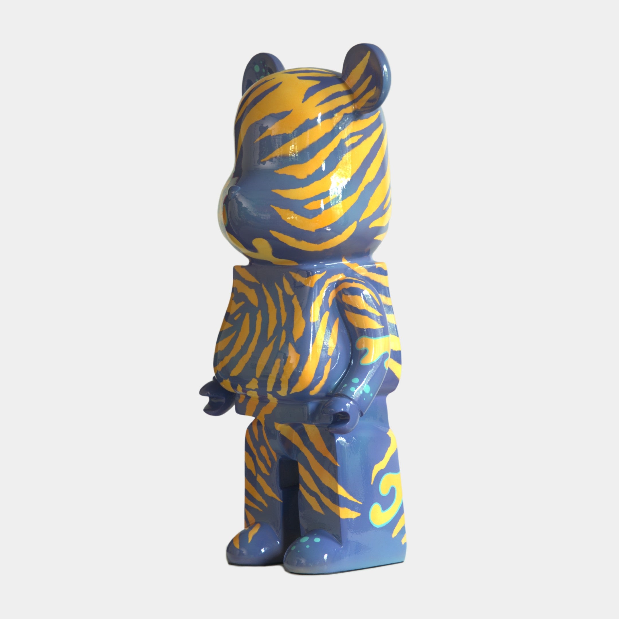 The Inside Appears Outside 2 Bear Sculpture (135cm) by Giant Sculptures is a bear-shaped figurine, hand-painted with blue and yellow tiger stripes, standing upright against a plain white background.