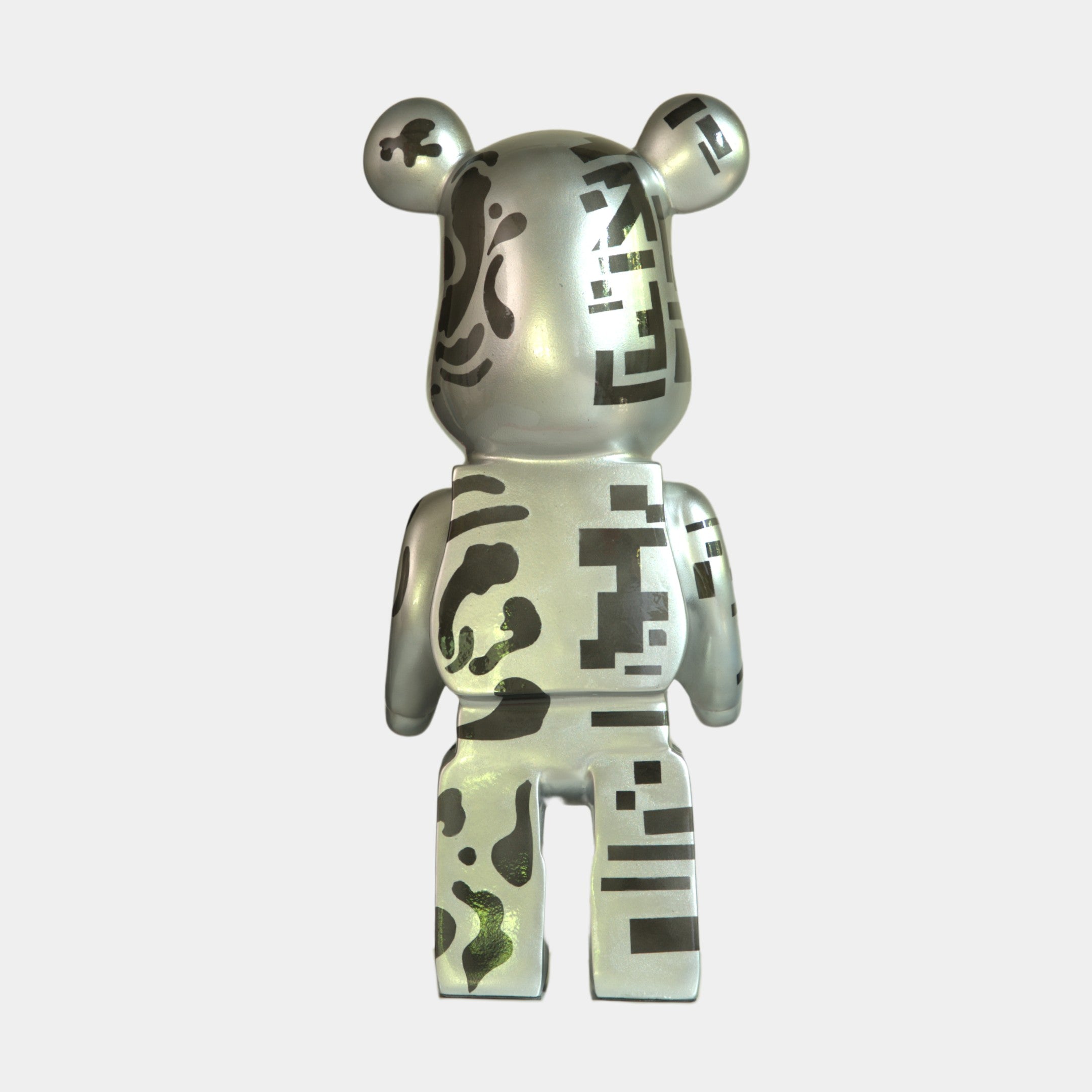 The Inside Appears Outside 3 Bear Sculpture - 165cm by Giant Sculptures features a metallic bear standing upright, viewed from behind, with a reflective silver finish and abstract black patterns with square, Futuristic Forms-inspired designs.