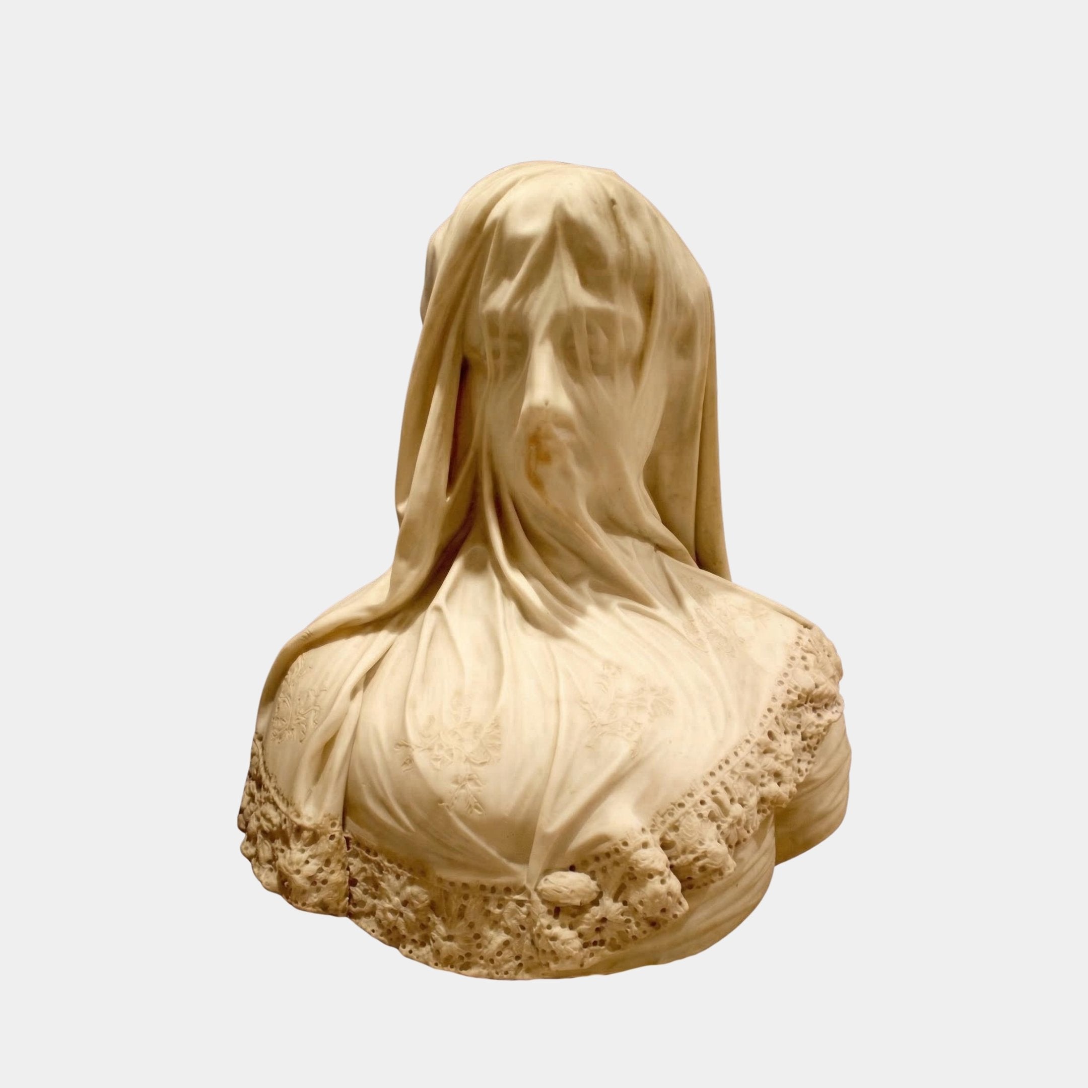 The Veiled Lady Marble Bust Sculpture - 60cm by Giant Sculptures depicts a woman with a finely carved translucent veil showing her features and lace details, set against a plain light background.