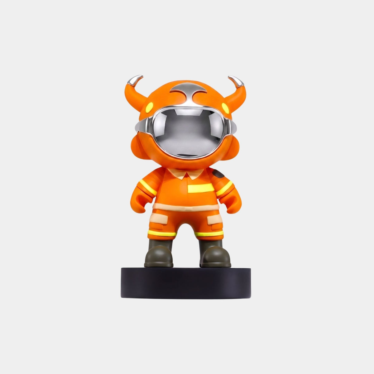 The Giant Sculptures Orange Utility Astro Devil Figure - 15cm features a chibi resin character in an orange suit with yellow accents, green boots, and a horned helmet, standing on a round black base against a white background.