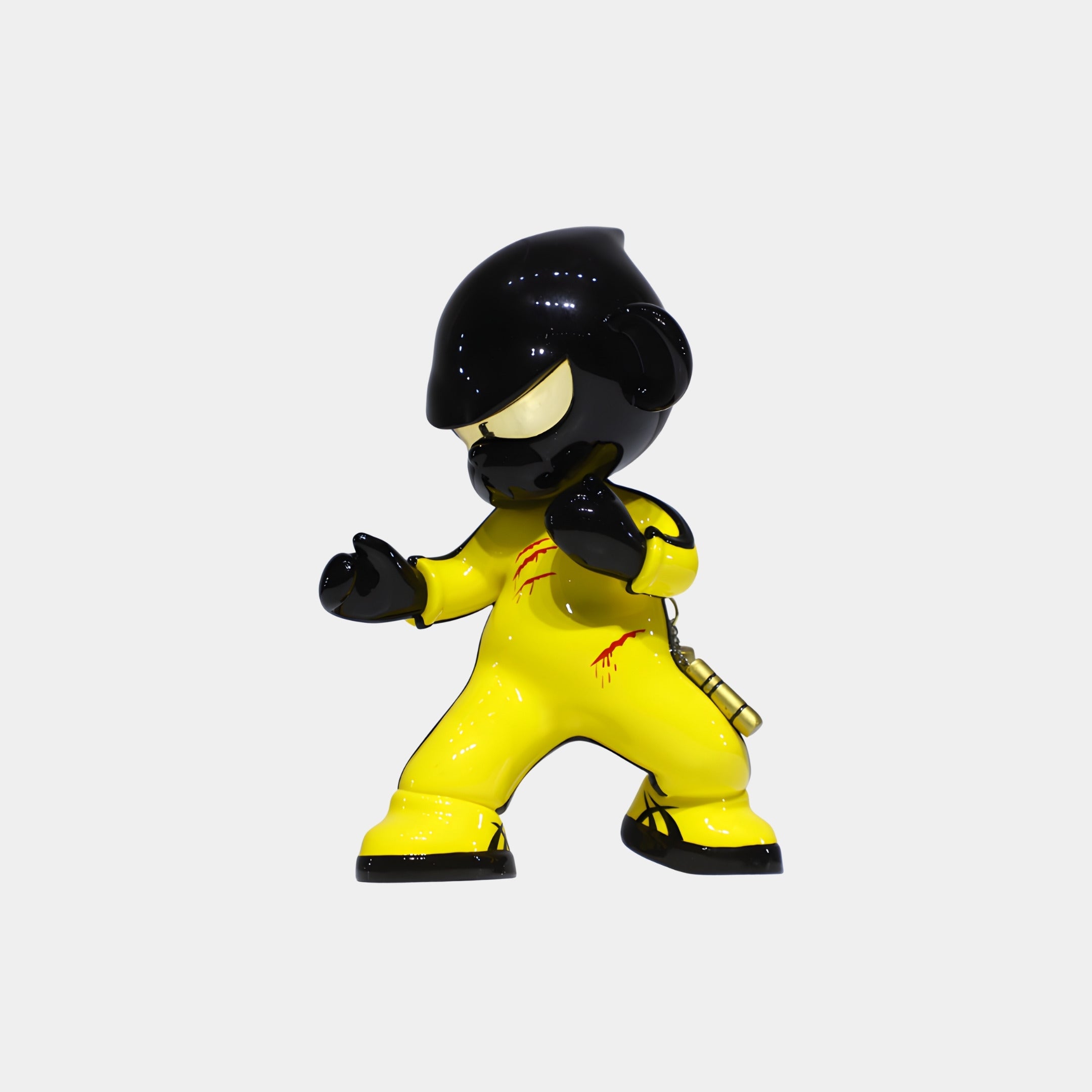 The Giant Sculptures Yellow Kung Fu Monkey Figure - 15cm features a stylized monkey in a yellow jumpsuit with black accents, an oversized head with black helmet, and posed in a martial arts stance. Resin collectible. Background is plain white.