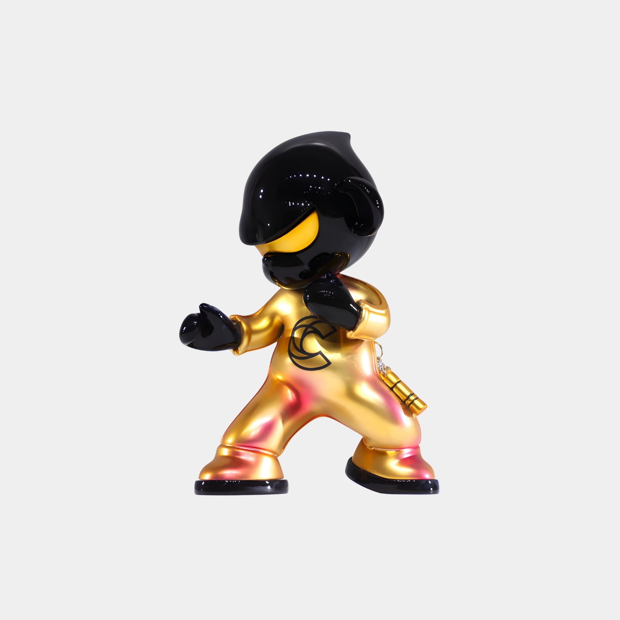 The Gold Kung Fu Monkey Figure - 15cm by Giant Sculptures is a black and metallic gold collectible art toy in shiny resin, featuring a helmet-like head and unique chest symbol, posed against a plain white background.