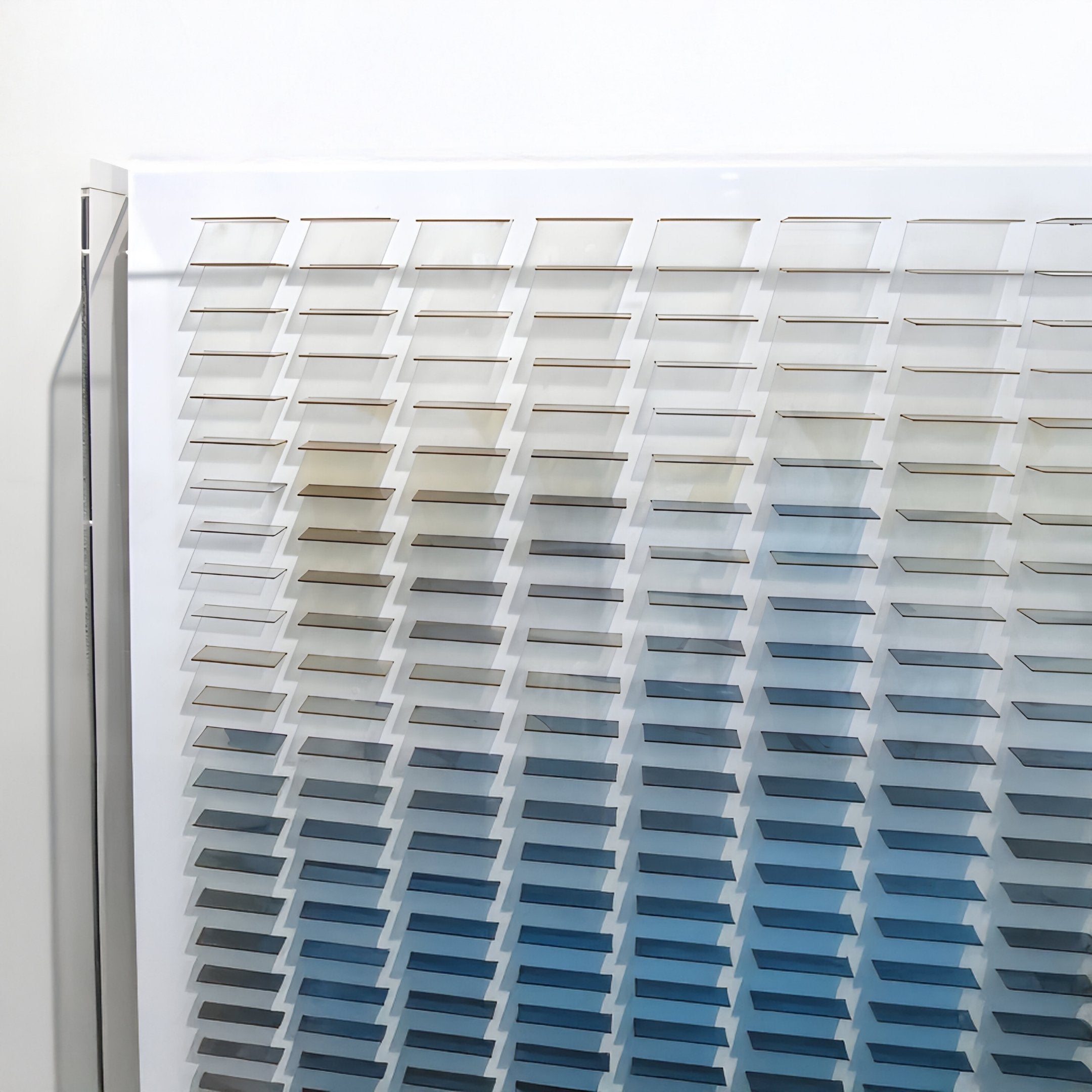 The Giant Sculptures Chromat Nebula Blue Gradient Acrylic 3D Wall Art features a grid of color blocks fading from neutral tones to blues, creating a bold contemporary statement piece for your wall decor.