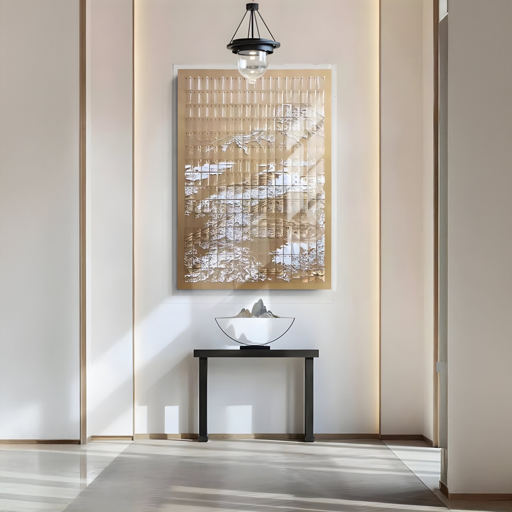 A minimalist interior features a modern black table with a white bowl and stones, beneath the Dynasty Golden Cliffs Acrylic 3D Wall Art by Giant Sculptures. Soft sunlight streams in, casting tranquil shadows.