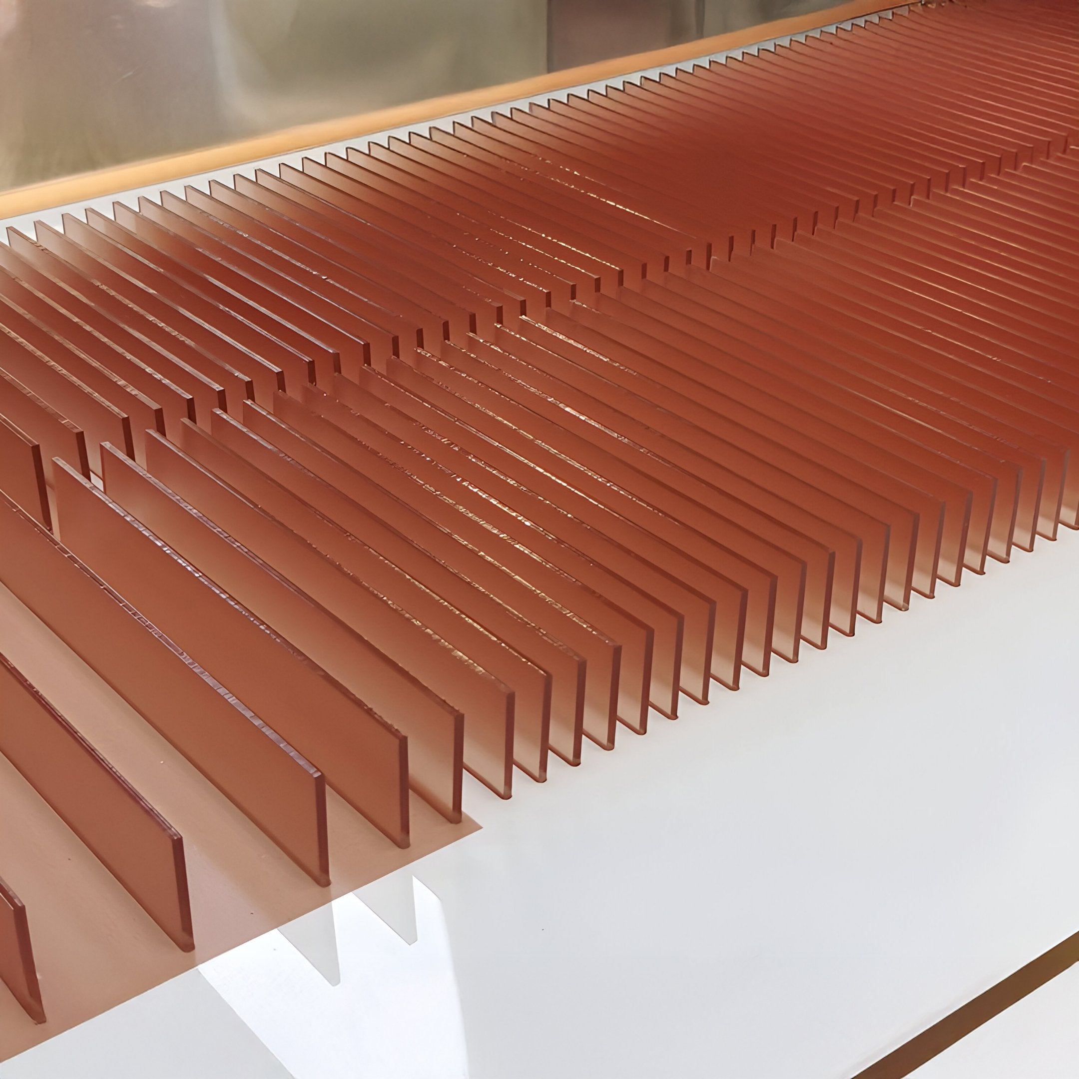 Flowline I Dual Tone Copper & Charcoal Acrylic 3D Wall Art by Giant Sculptures features rectangular panels in parallel rows on a white base, creating a striking modern geometric pattern—ideal as contemporary wall decor.