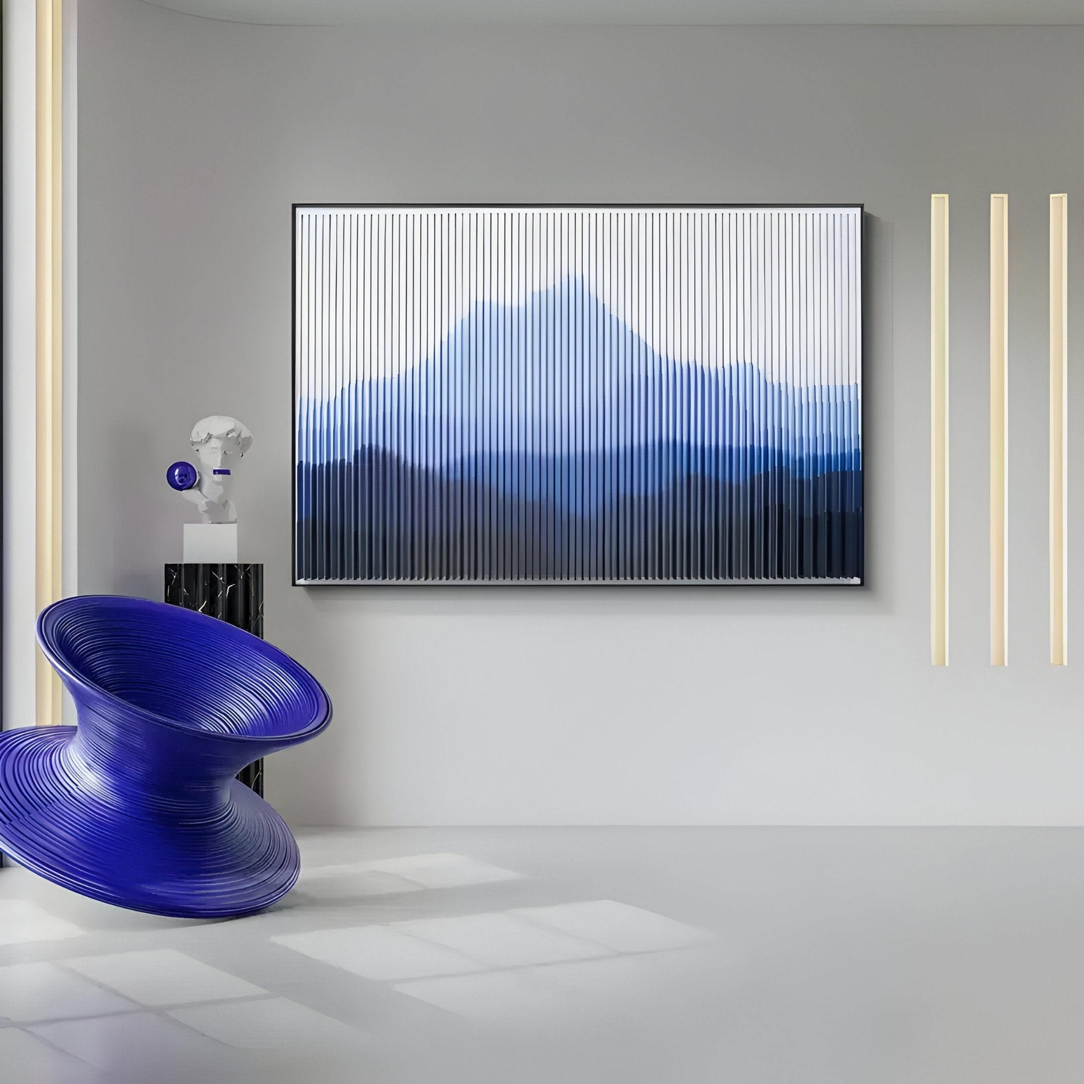 A modern minimalist room features a blue spiral chair, Horizon Indigo Sky Mountain Acrylic 3D Wall Art by Giant Sculptures, vertical light strips, and a small decorative sculpture on a pedestal. The space is bright with natural light.