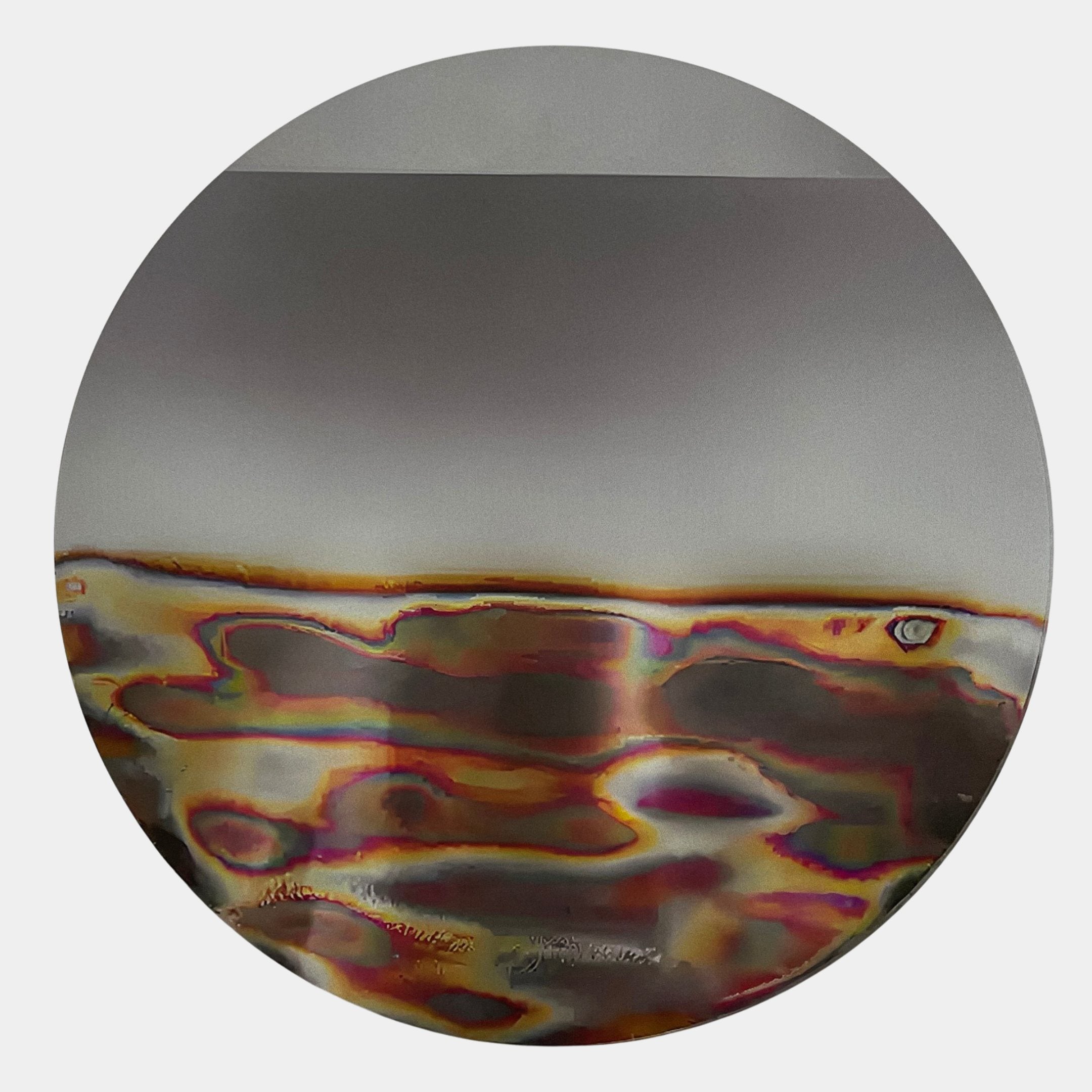 Iridia Halo III Abstract Acrylic UV Wall Art by Giant Sculptures, circular disc with mirrored upper half and multicoloured wavy heat-mark lower band on a white wall.