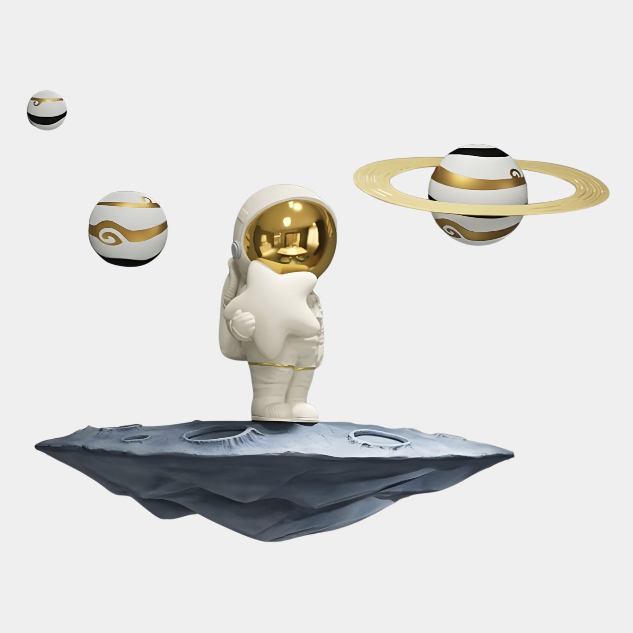 The White & Gold Orbit Odyssey Star Astronaut 3D Wall Art by Giant Sculptures features a small astronaut holding a star on a floating rock, surrounded by three decorative planets—an ideal space-inspired décor accent for any room.