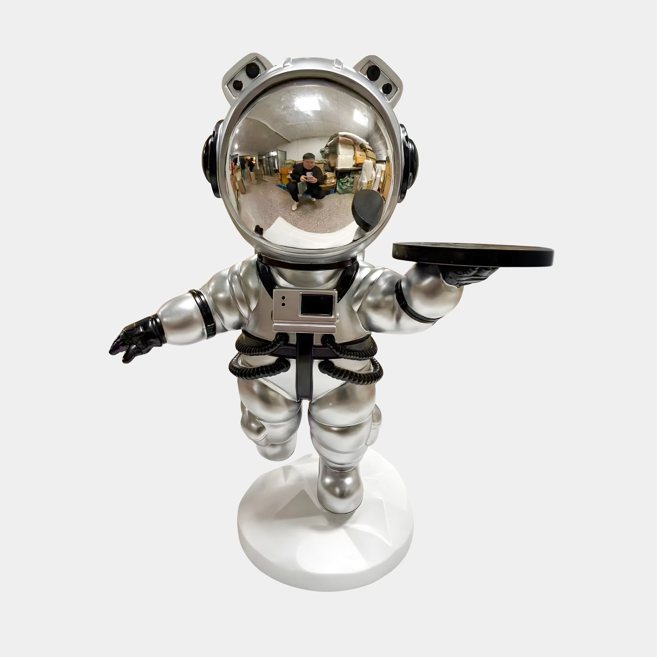 The Astral Silver Astronaut Bear Butler Sculpture by Giant Sculptures stands 90cm tall on one leg, holding a round black tray. Its reflective helmet adds space-themed charm, making it a striking home accent against any plain background.