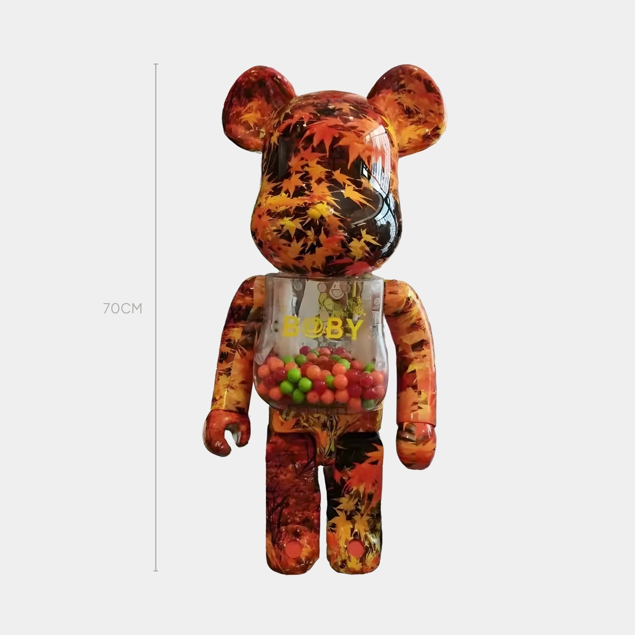The Autumn Foliage Bear Sculpture - 70cm by Giant Sculptures features an autumn leaf motif, a transparent belly filled with colorful gumballs, and BABY on its chest—ideal for bringing seasonal style to your space.