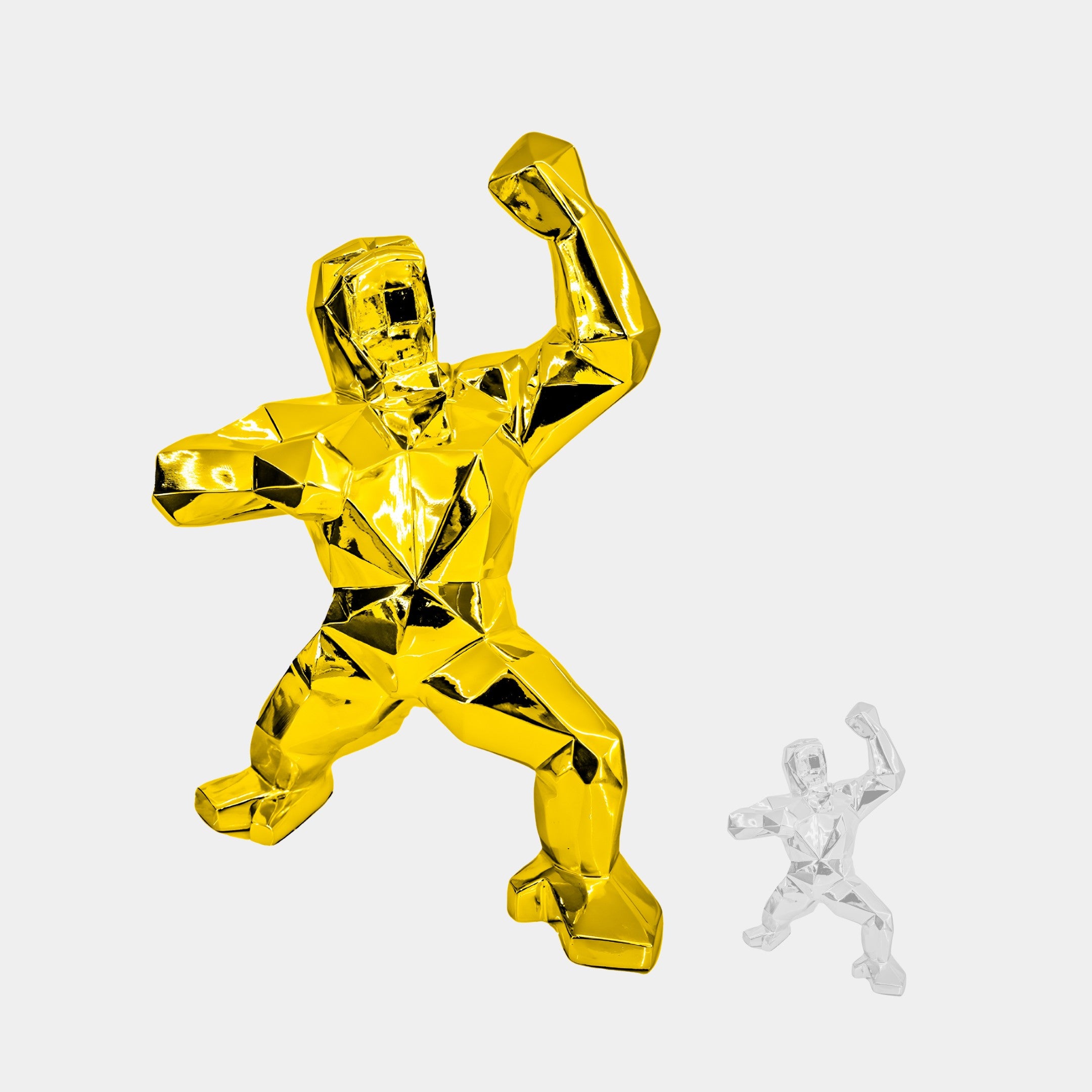 Two faceted sculptures showcase stylized figures in strong poses: a large gilded gold gorilla (165cm) by Giant Sculptures and a smaller clear figure, both embodying a modern geometric aesthetic against a plain white background.
