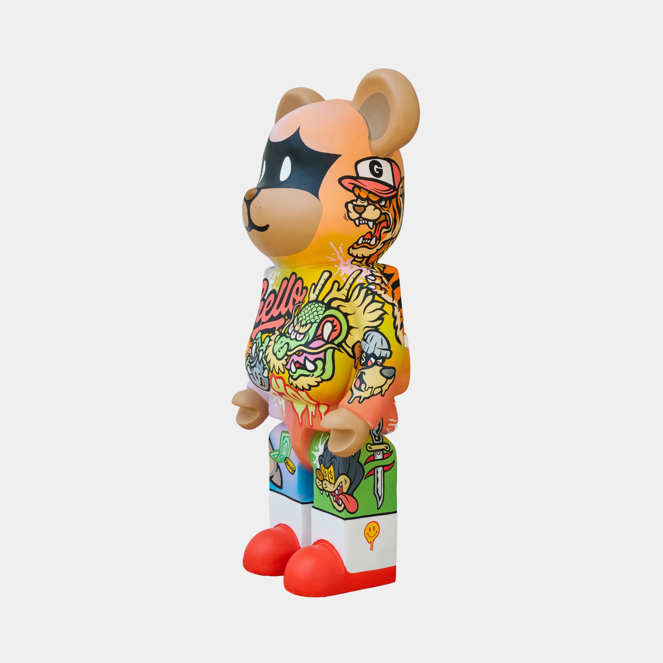 The Lucky Paws Bear Sculpture - 50cm by Giant Sculptures is a vibrant, limited edition collectible featuring a colorful bear-shaped figurine with a mask-like face, graffiti-style designs, abstract shapes and characters. It stands stylishly in bright red shoes against a neutral background.