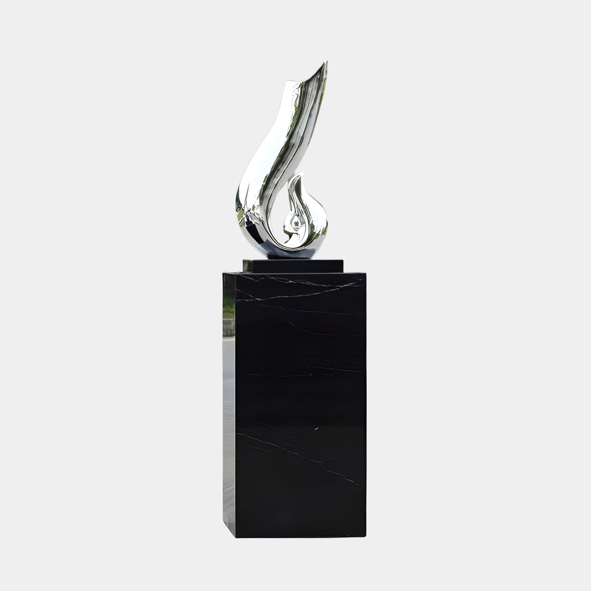 Bramford Silver & Black Abstract Sculpture, 182cm fibreglass flame-like form with mirror-bright silver finish on a black plinth, shown against a plain white background.