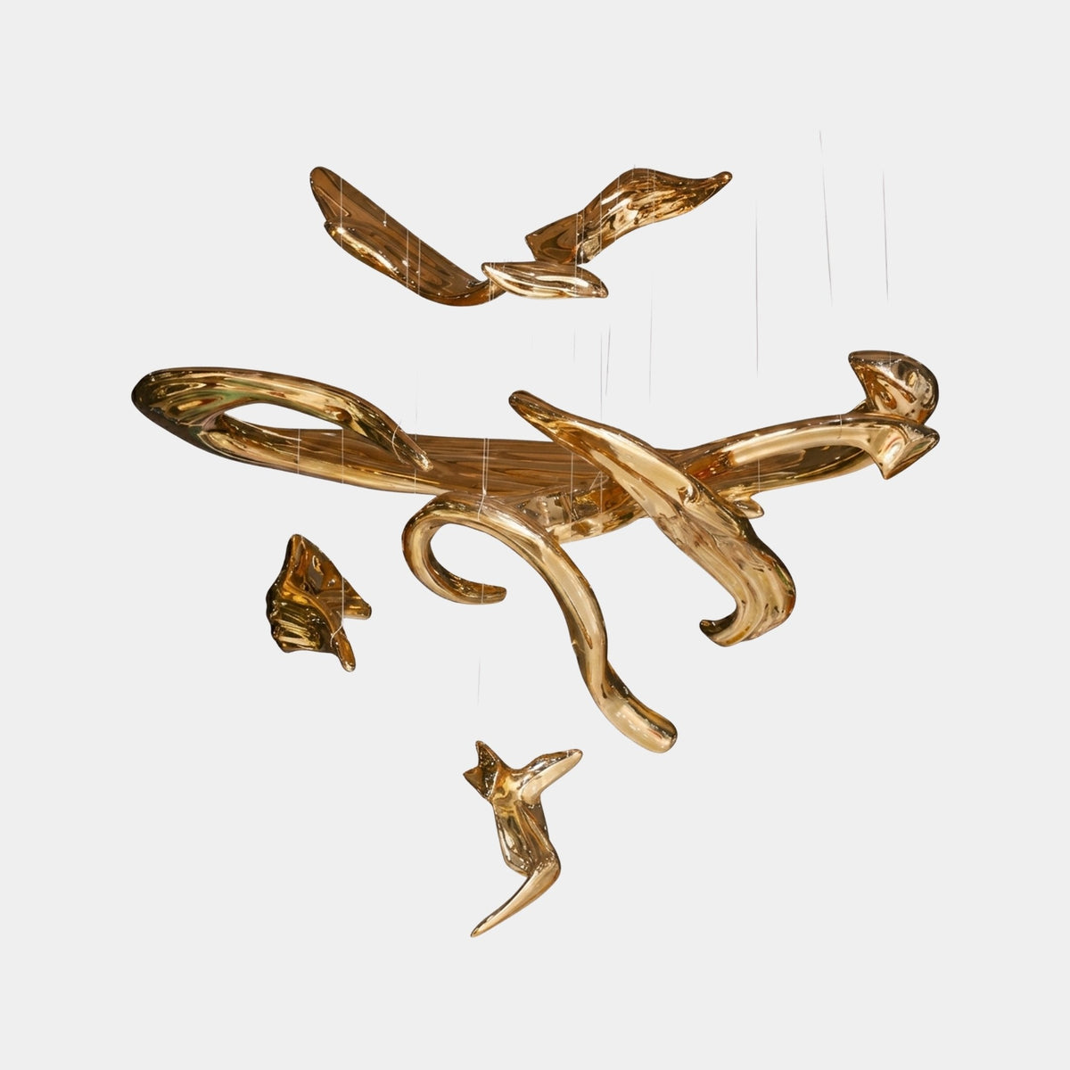 Cranbury Gold Abstract Sculpture - 130cm, a fibreglass ribbon-form piece in mirror-bright gold with curling, flowing contours, shown suspended against a plain light background.
