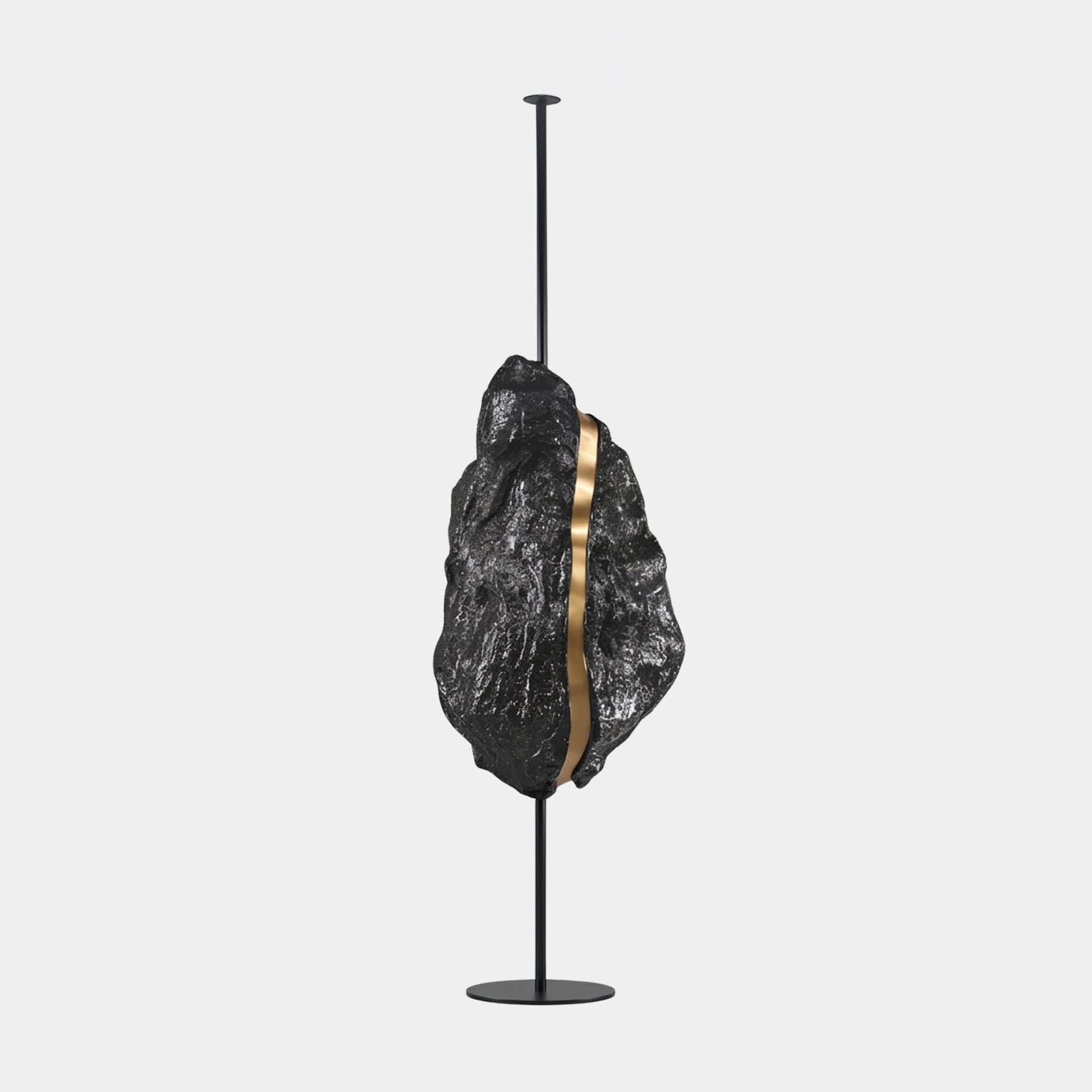 Ravenstone Black & White Abstract Sculpture, 120cm, fibreglass leaf-feather form with gold band on black metal stand, plain light grey background.