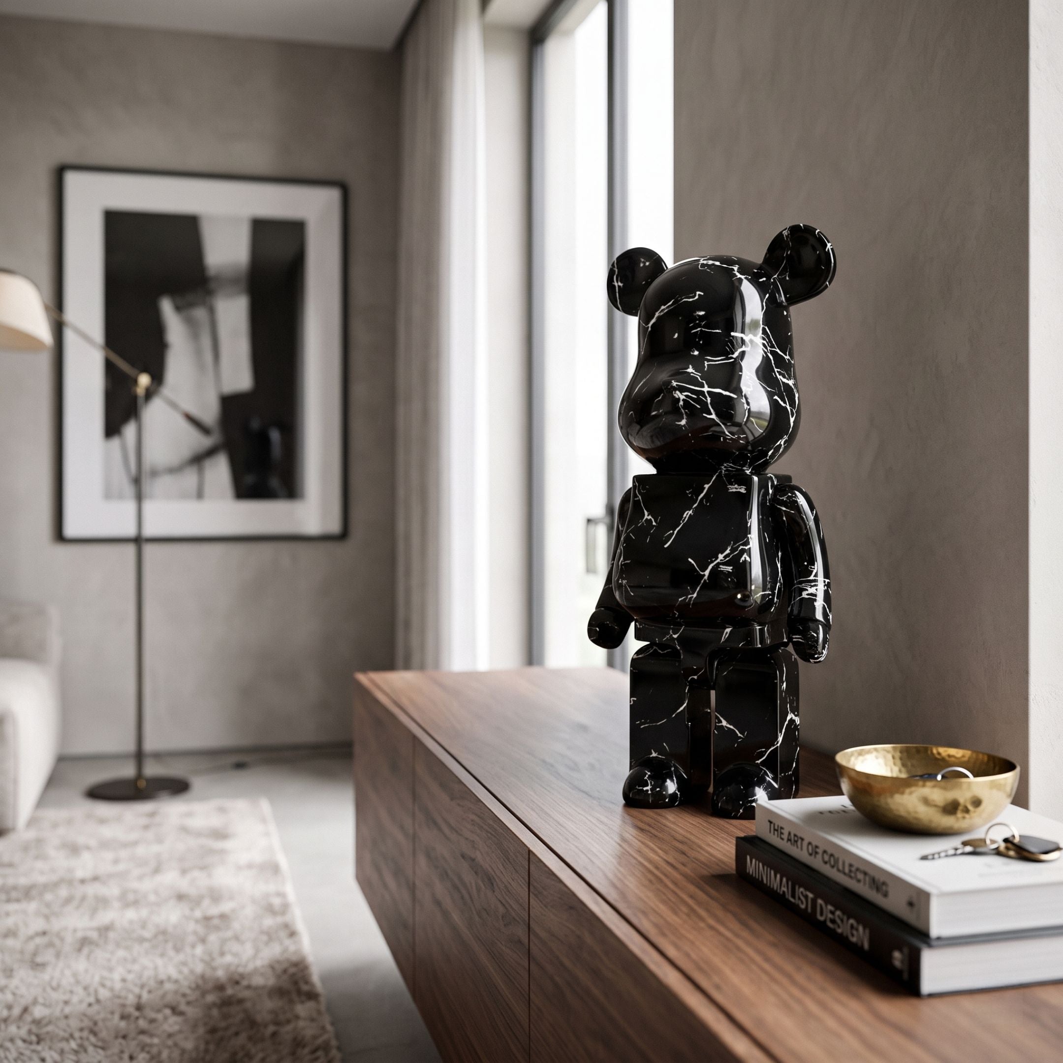 Giant Sculptures Black Stone Bear Sculpture (50cm) with marbled silver-veined finish, displayed on a walnut sideboard beside books and a brass bowl in a modern living room.
