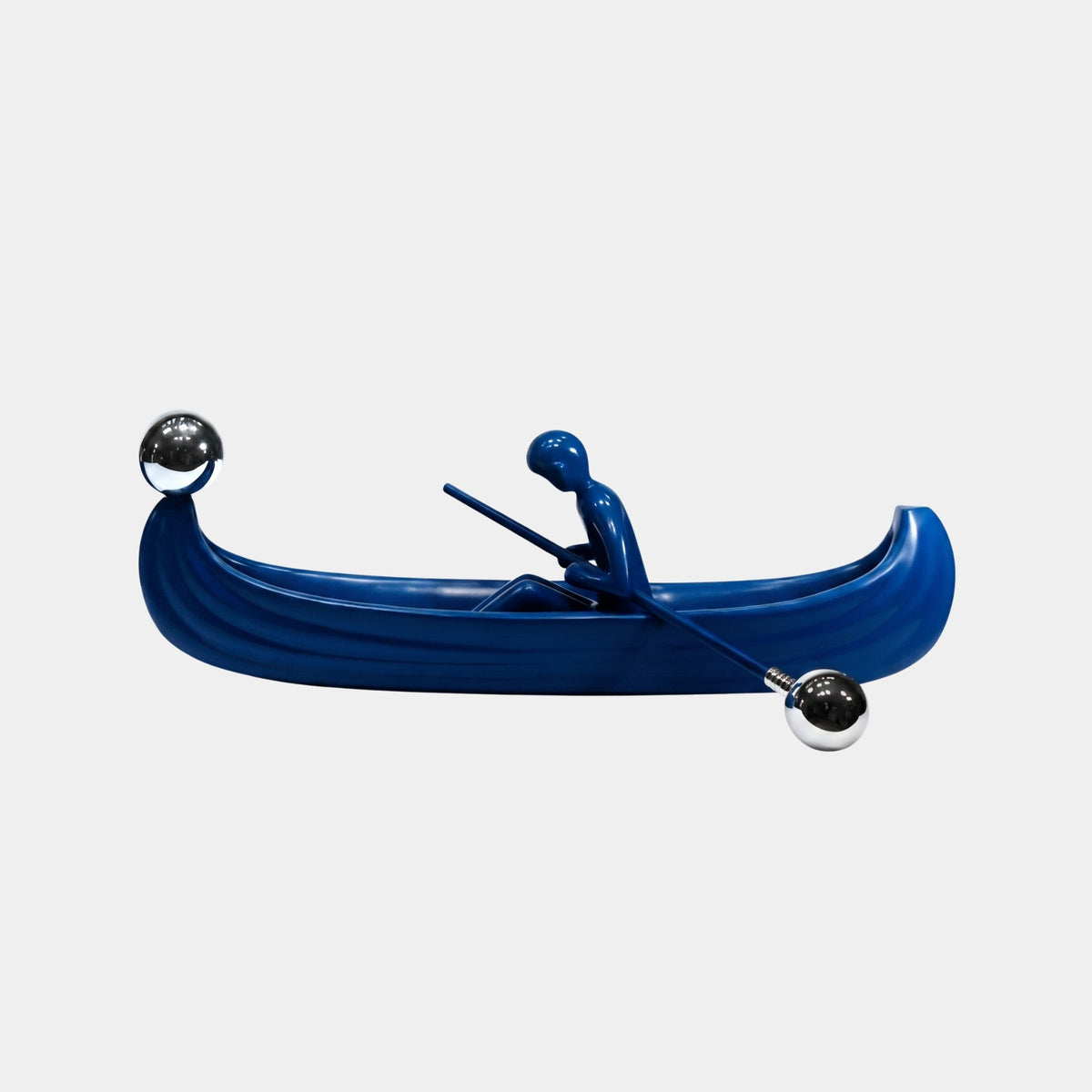 Crancote Blue Boat Sculpture (100cm) by Giant Sculptures, a fibreglass canoe with a rowing figure in blue and chrome oar tips, shown on a plain white background.