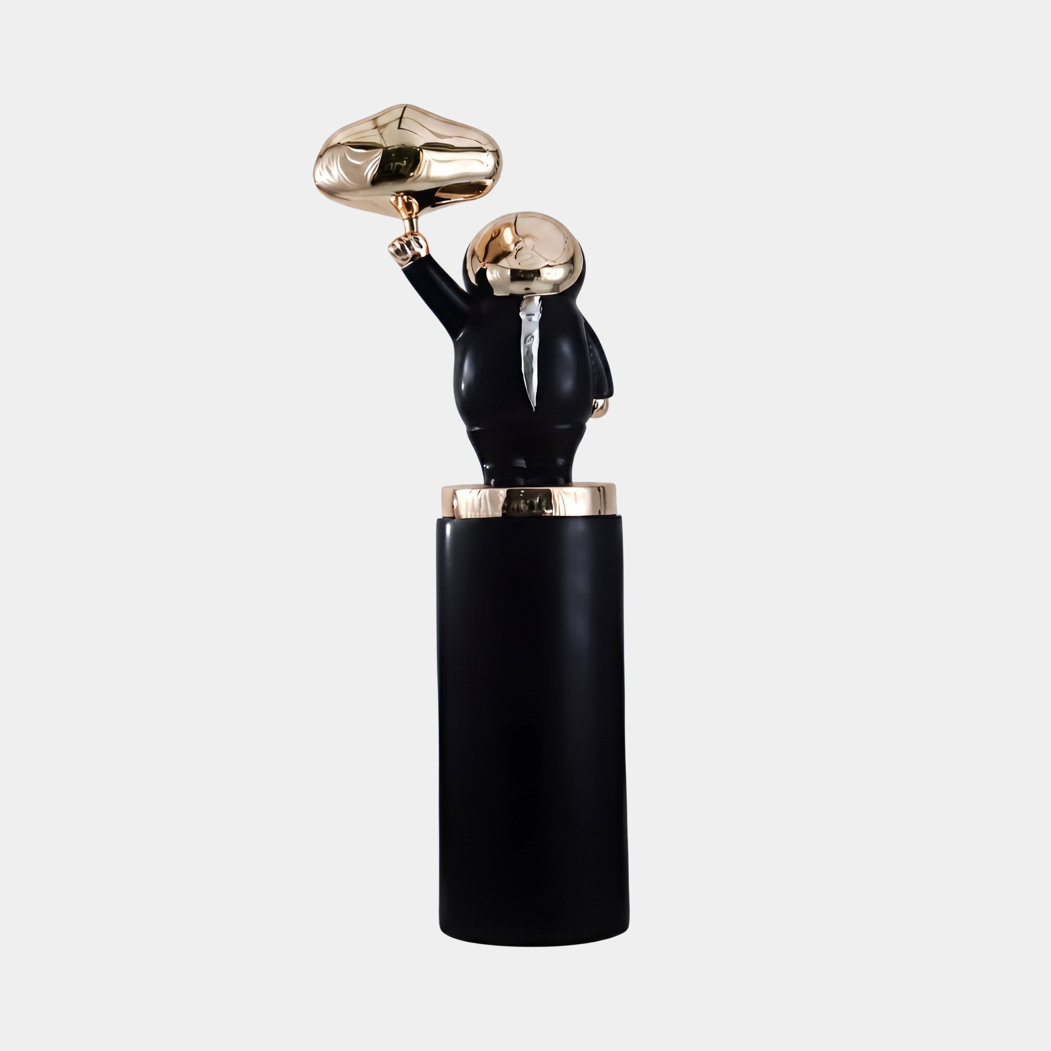 Dunholme Black & Silver Astronaut Sculpture, 130cm fibreglass figure with raised gold-toned helmet arm atop a black cylindrical column, shown on a plain light grey background.