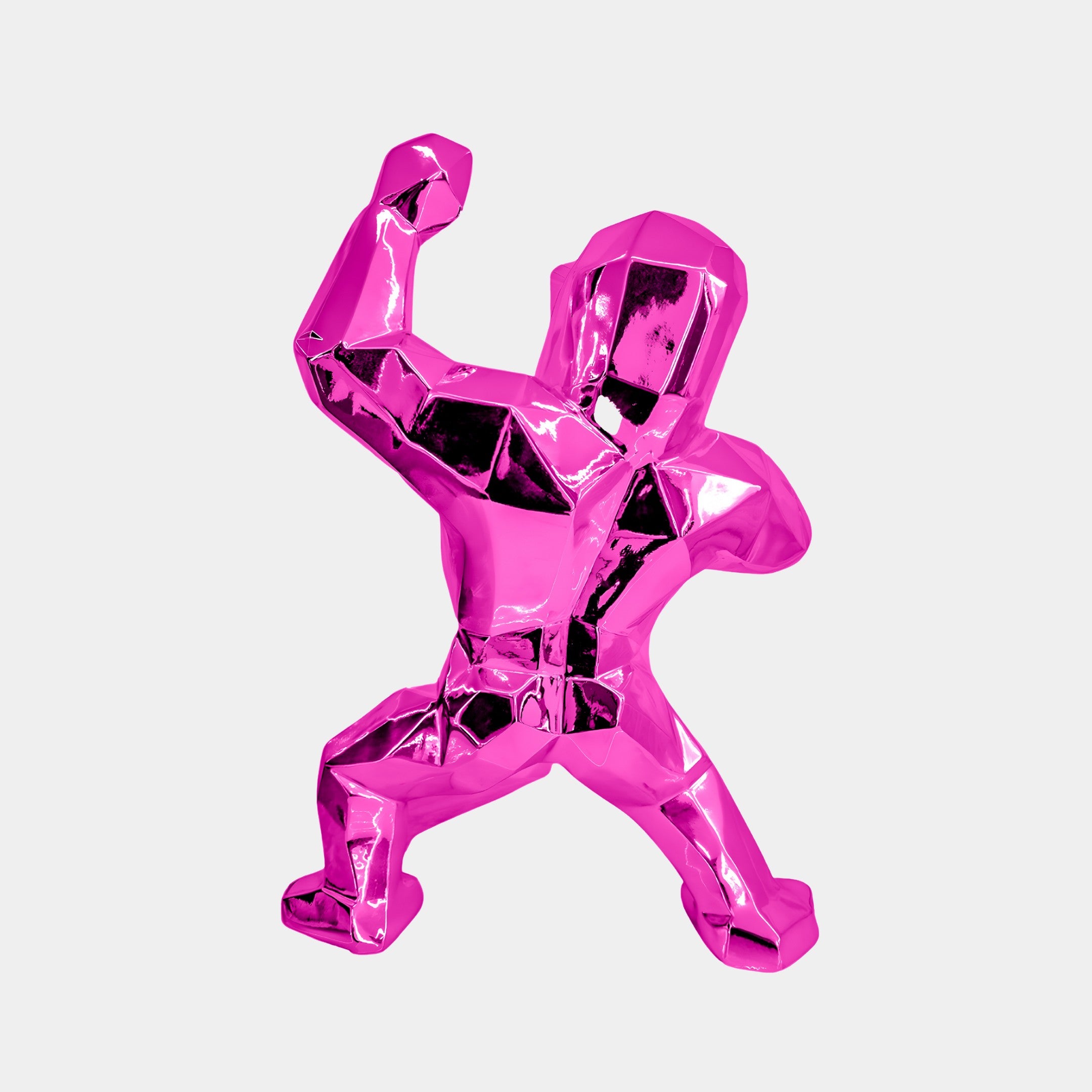 The Flamingo Pink Gorilla Sculpture by Giant Sculptures, standing at 50cm, is a faceted, metallic piece of contemporary art featuring a stylized figure in dynamic pose against a plain white background, crafted from premium resin.