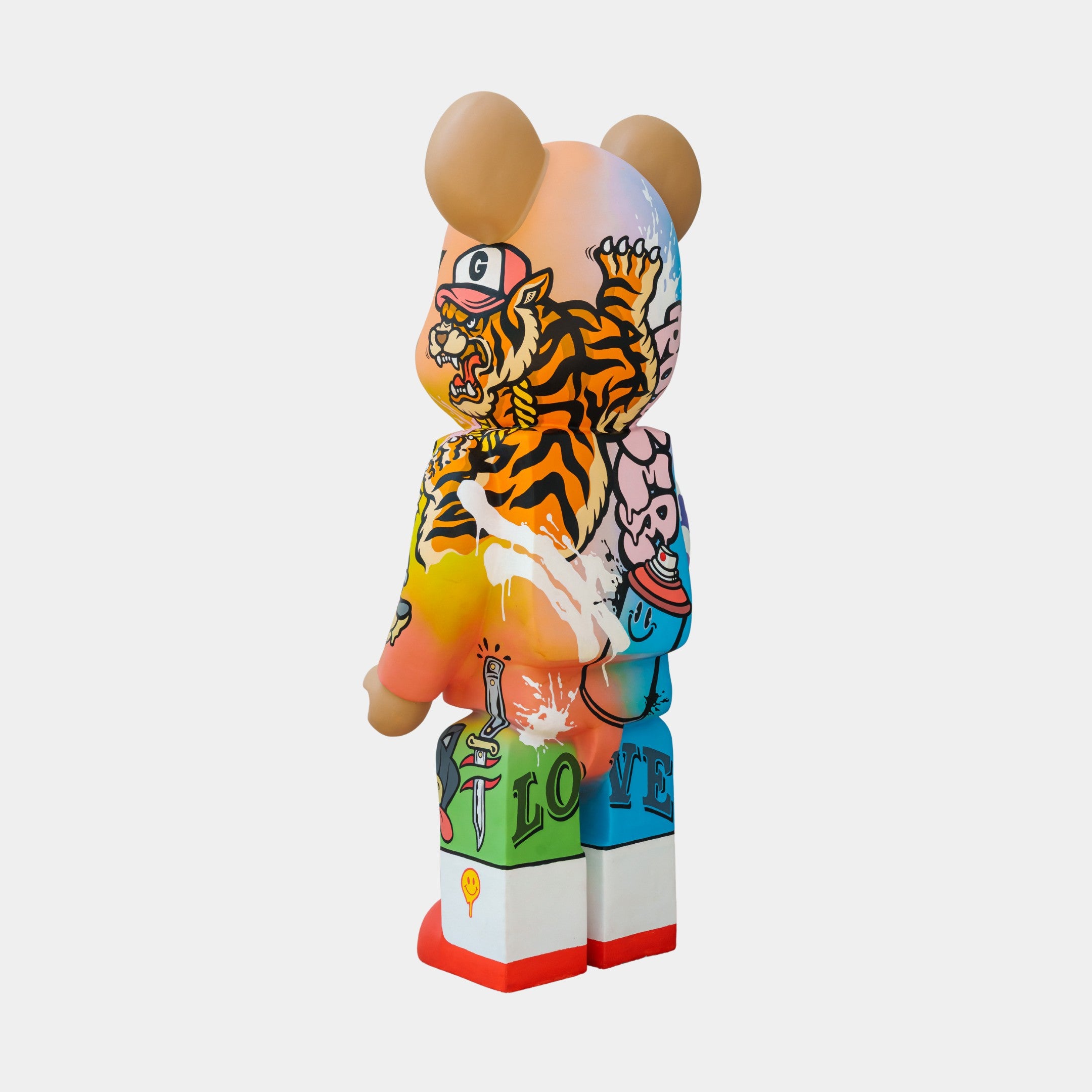The limited-edition 165cm Lucky Paws Bear Sculpture by Giant Sculptures features tan ears and a colorful design with vibrant graffiti-style Thai street art. Its body showcases a roaring tiger in orange and black surrounded by abstract shapes in bright pink, blue, and red.