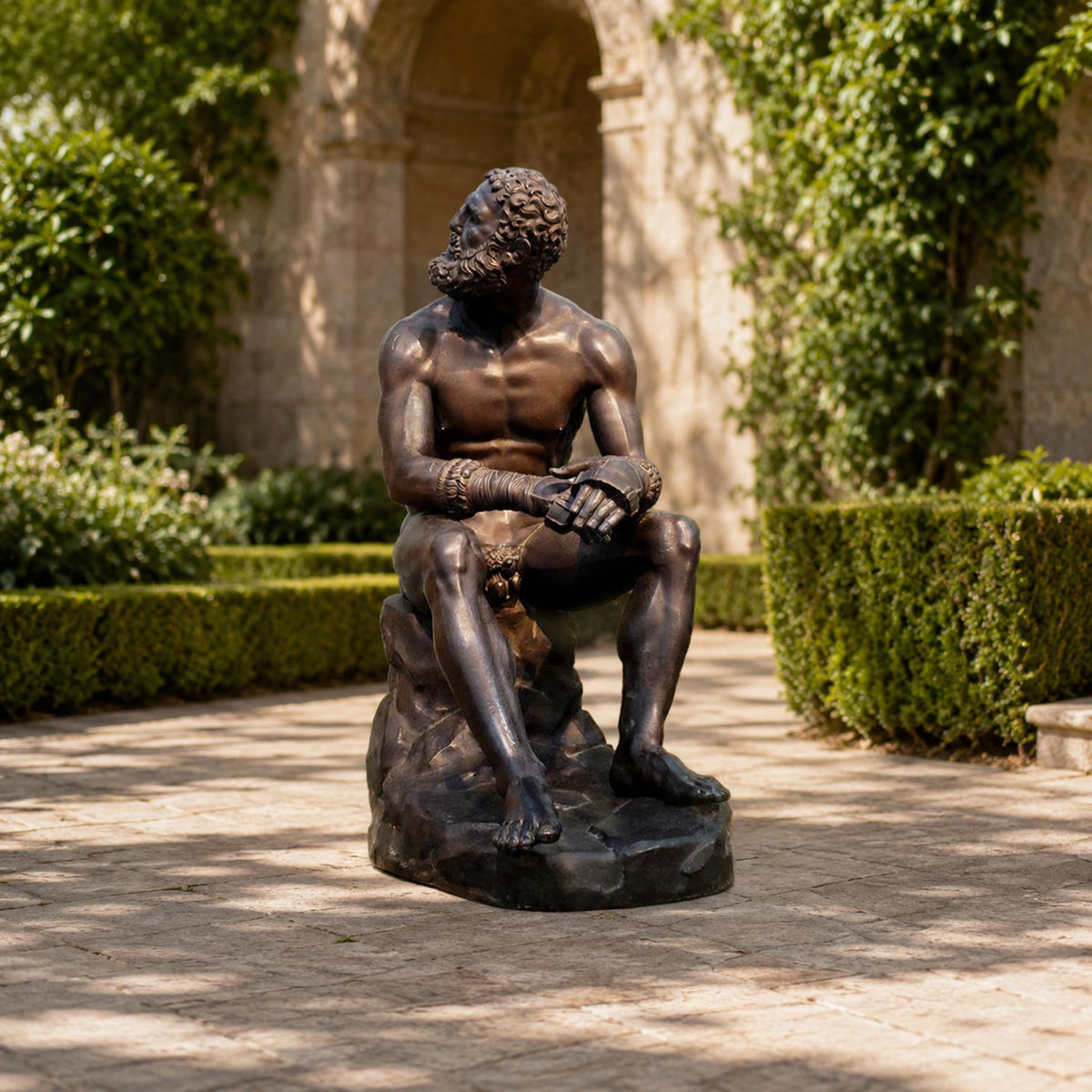 Large Classical Seated Boxer Bronze Sculpture, 130cm, seated bare-chested figure with wrapped wrists on a rock base, displayed outdoors on a stone courtyard patio.