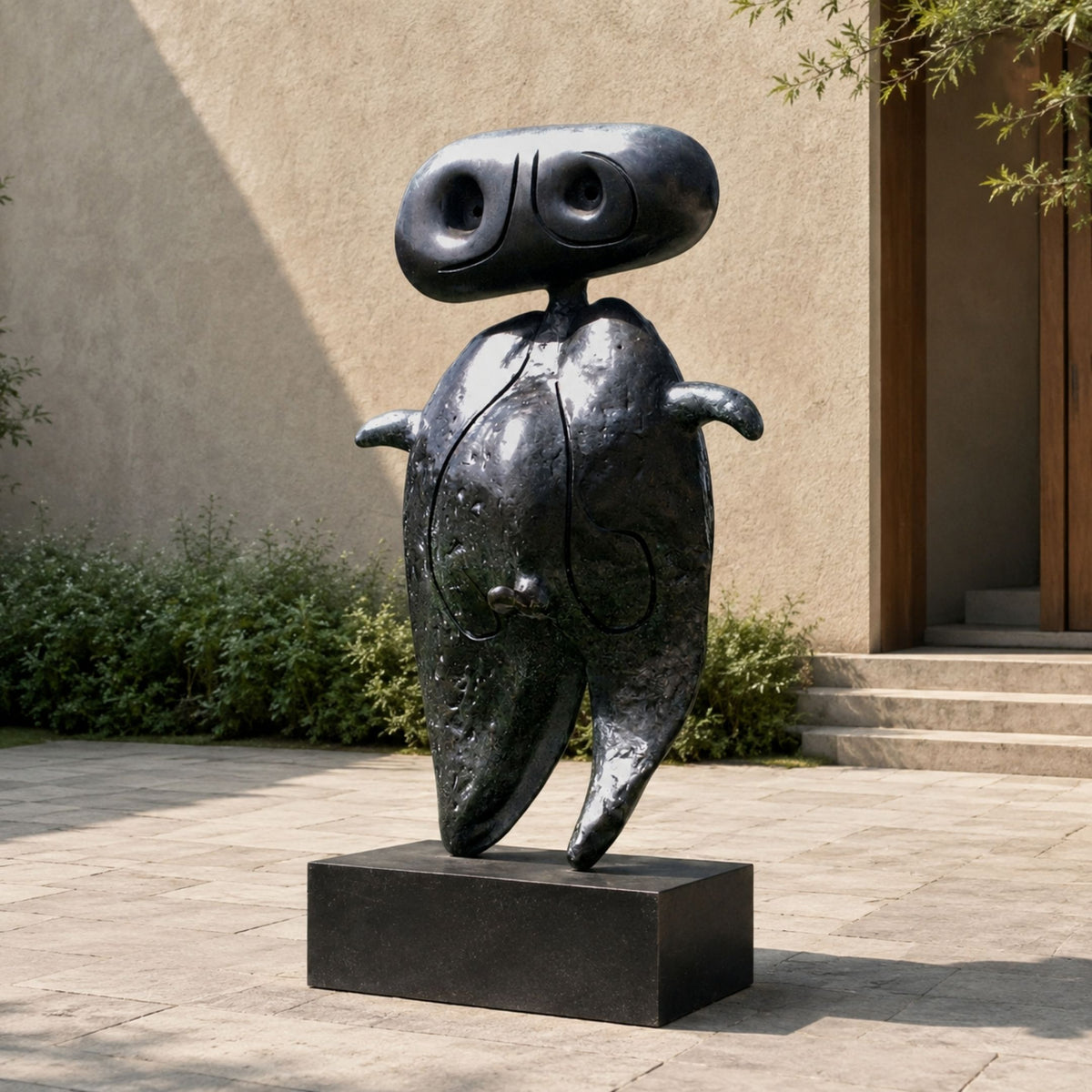 Large Modern Abstract Anthropomorphic Figure Bronze Sculpture, 220cm, black patina on a rectangular base, displayed on a courtyard patio near greenery.