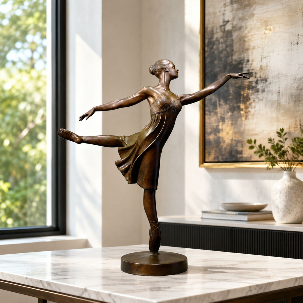 Contemporary Ballerina en Pointe Bronze Sculpture, 60cm, on a round base on a marble table with a window and framed art in a living room.