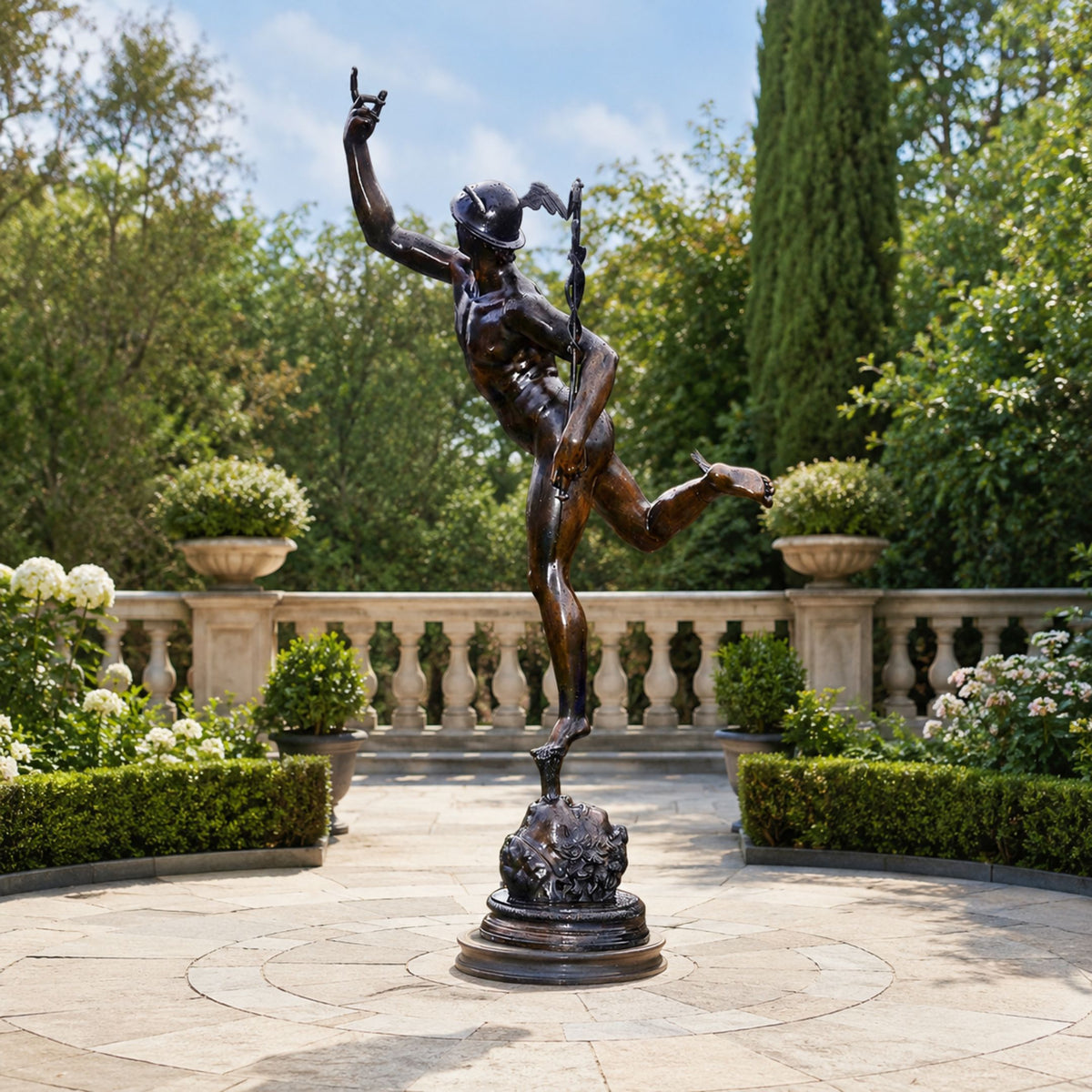 Monumental Classical Mercury Bronze Sculpture, 250cm, depicting Mercury mid-stride with raised arm and caduceus, displayed on a stone patio terrace with balustrade and greenery.