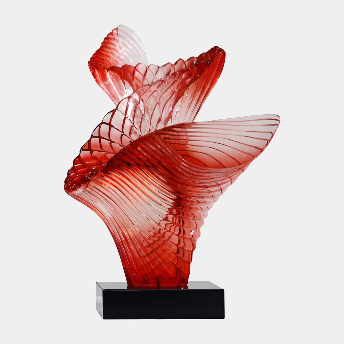 Red Fanned Spiral Resin Sculpture - 63cm, with three ribbed fans swirling from a red base to pale pink edges, set on a black stand against a white background.