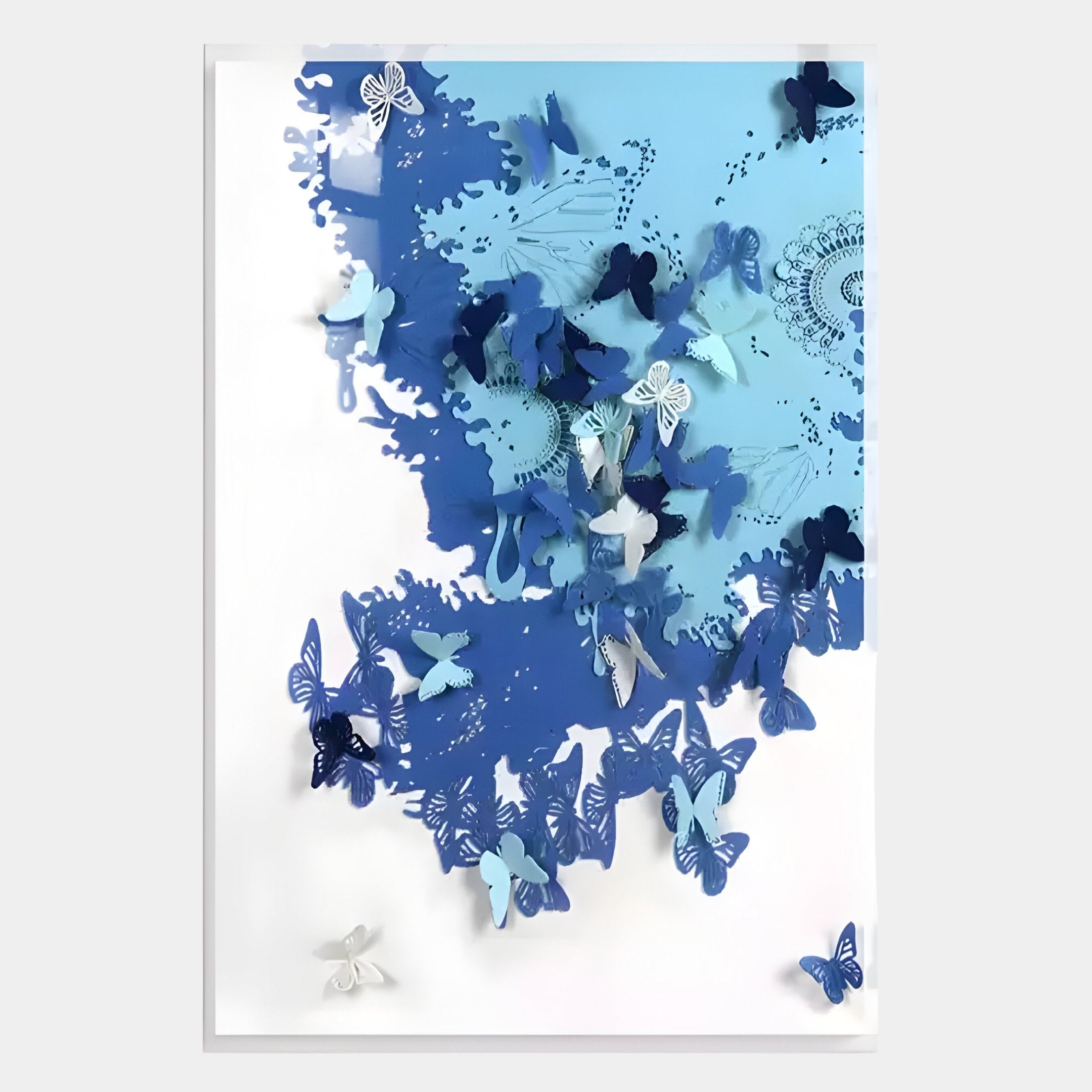 The Luminara Blue I Butterfly Paper 3D Wall Art by Giant Sculptures features layered blue and white butterflies arranged to appear as if flying from a lacy pattern into a white background, adding Nordic elegance to your space.
