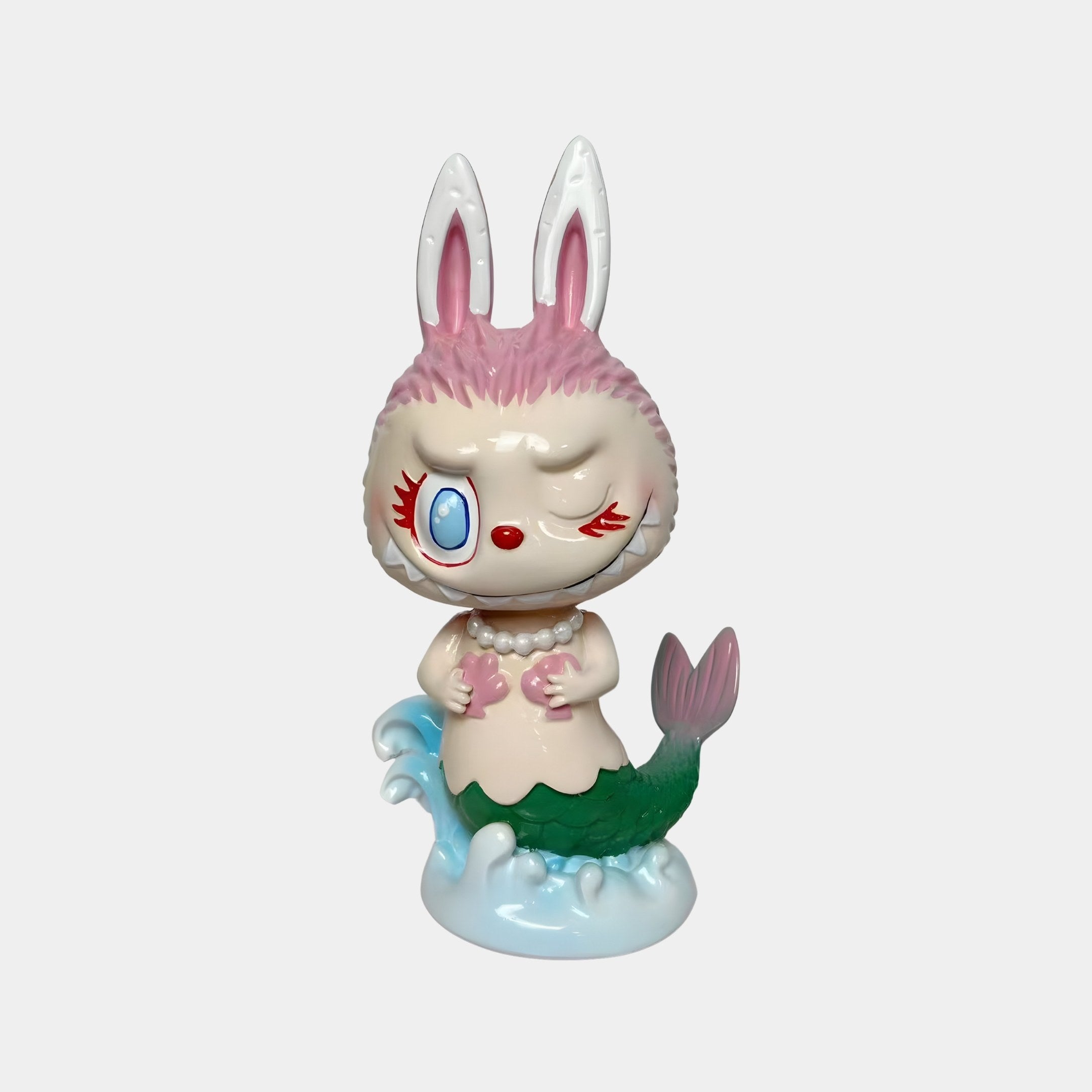 The Carnival Secret Mermaid Labubu Figure (30cm) by Giant Sculptures features a winking bunny-mermaid with pink fur, big ears, a pearl necklace, and green fish tail atop blue waves—ideal for fantasy décor.