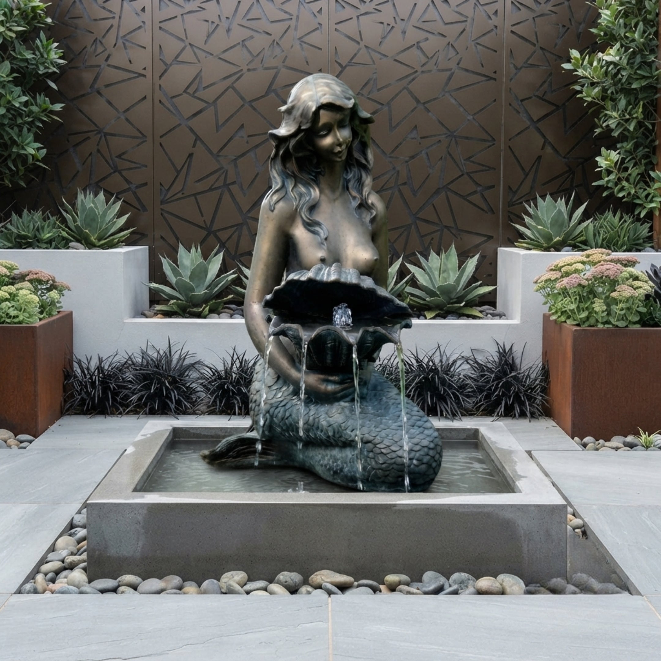 Classical Seated Mermaid Bronze Fountain by Giant Sculptures with antique patina, water cascading from a clamshell into a square pool in a courtyard garden.